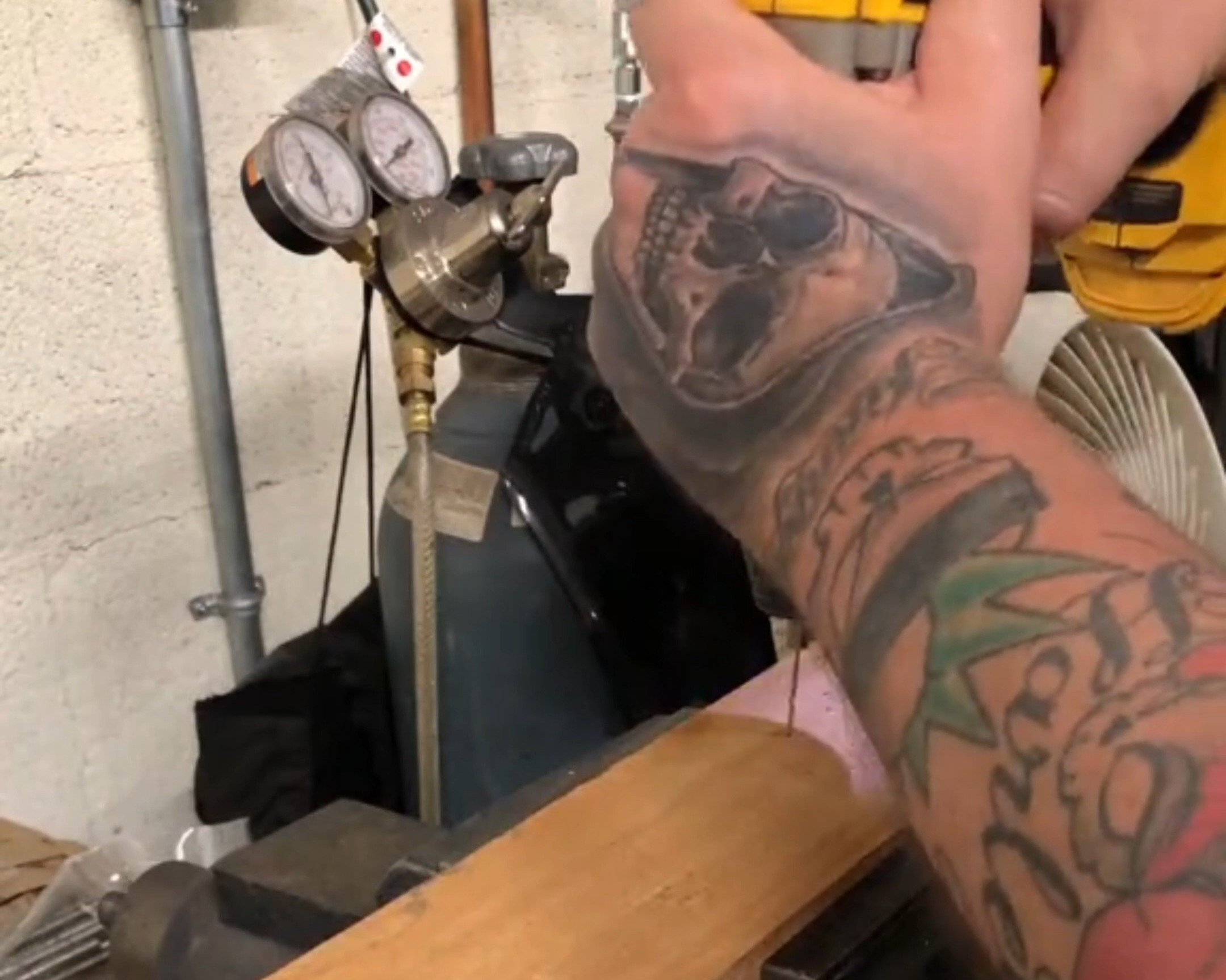 Drilling mounting holes into scrap lumber for toggle clamp.
