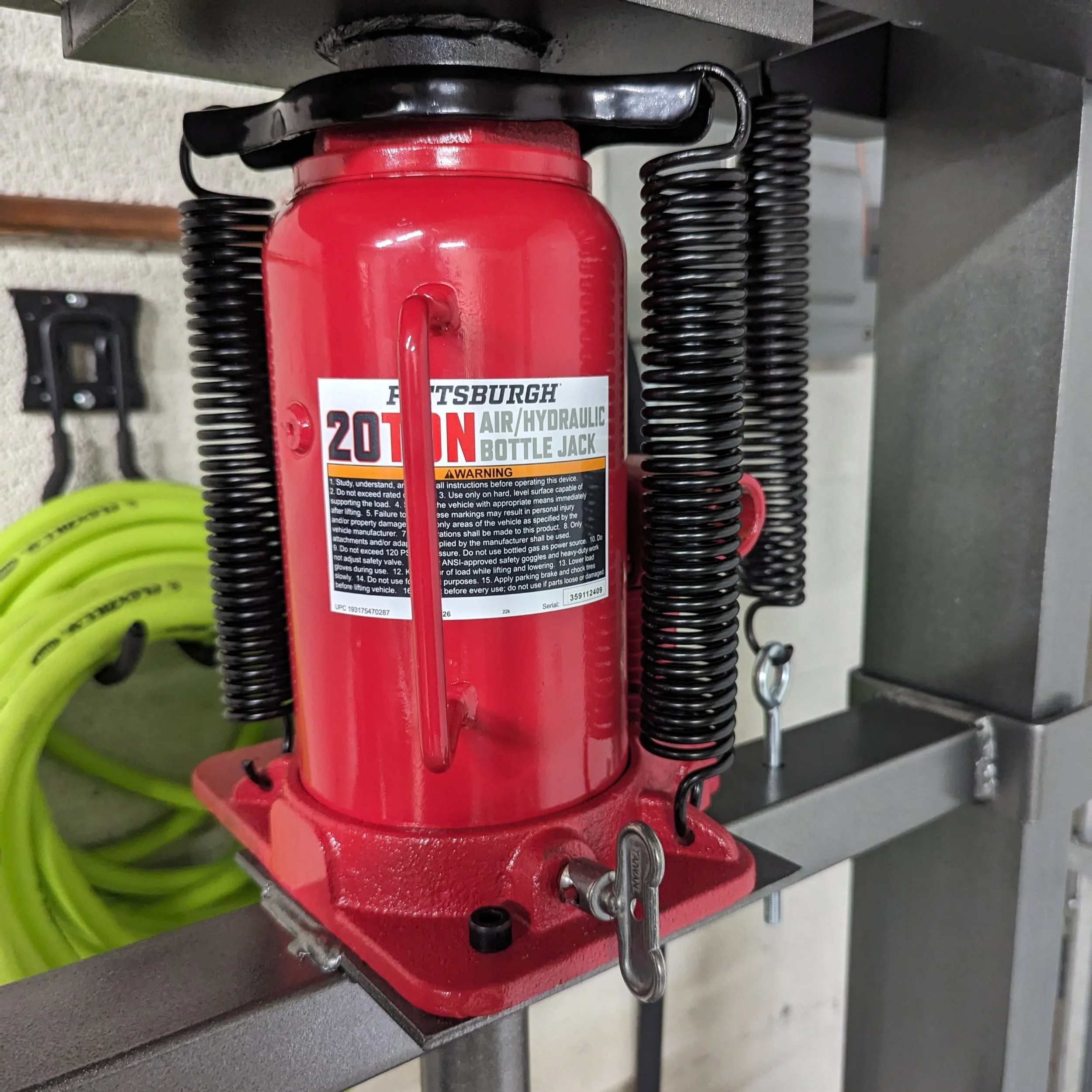 Upgraded air-over-hydraulic jack replacing the original bottle jack.