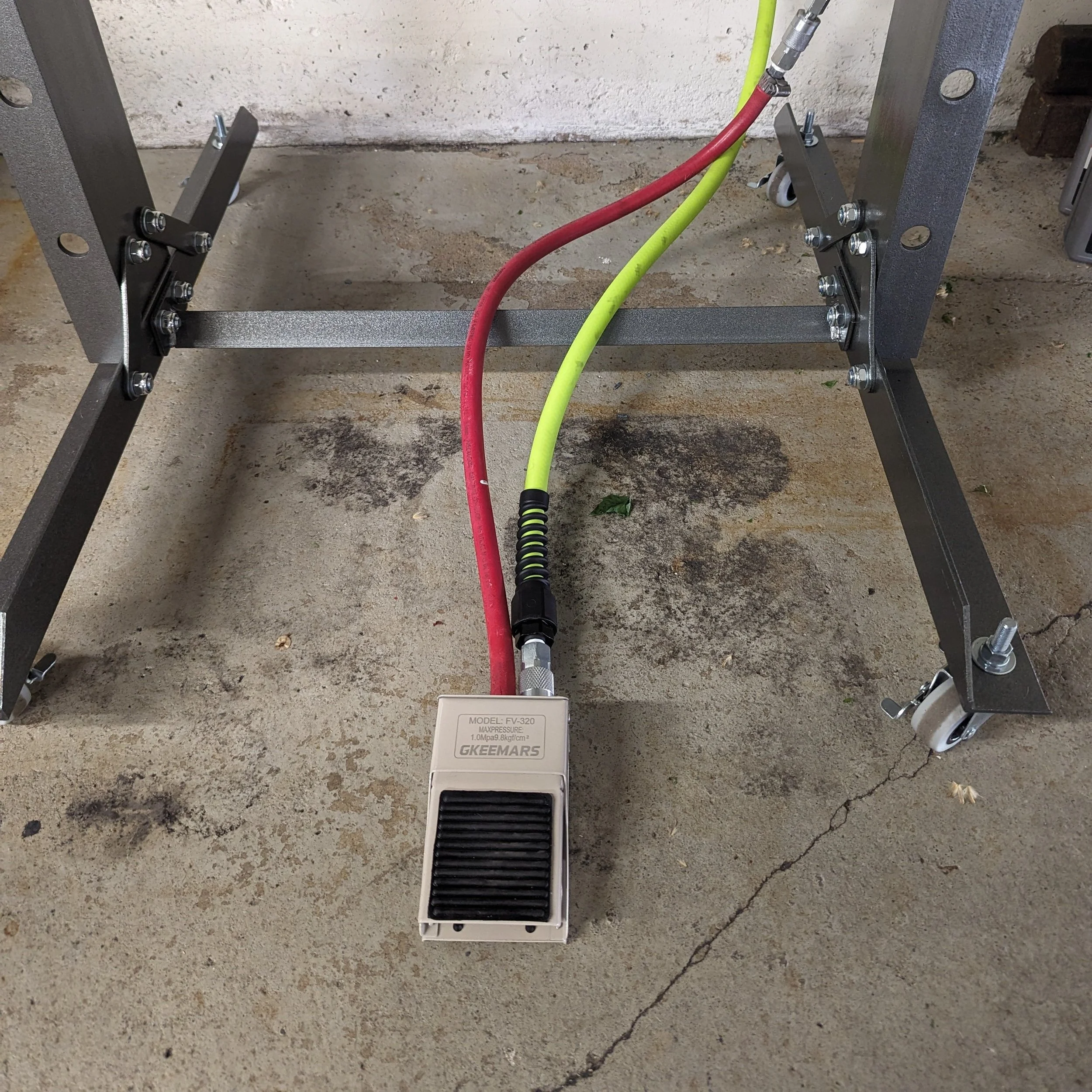 Foot pedal used to control the air-over-hydraulic jack on the shop press.
