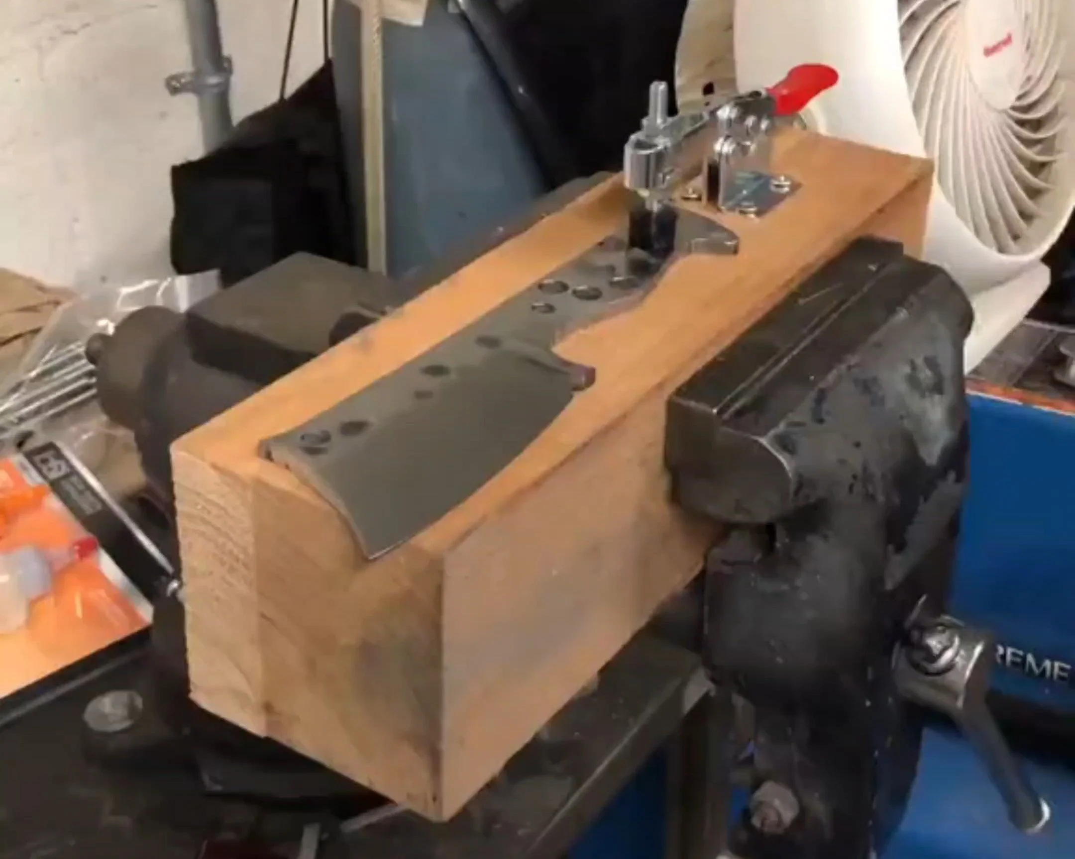 Completed budget knife vise built from scrap lumber and a toggle clamp holding a knife securely in place for detail work.