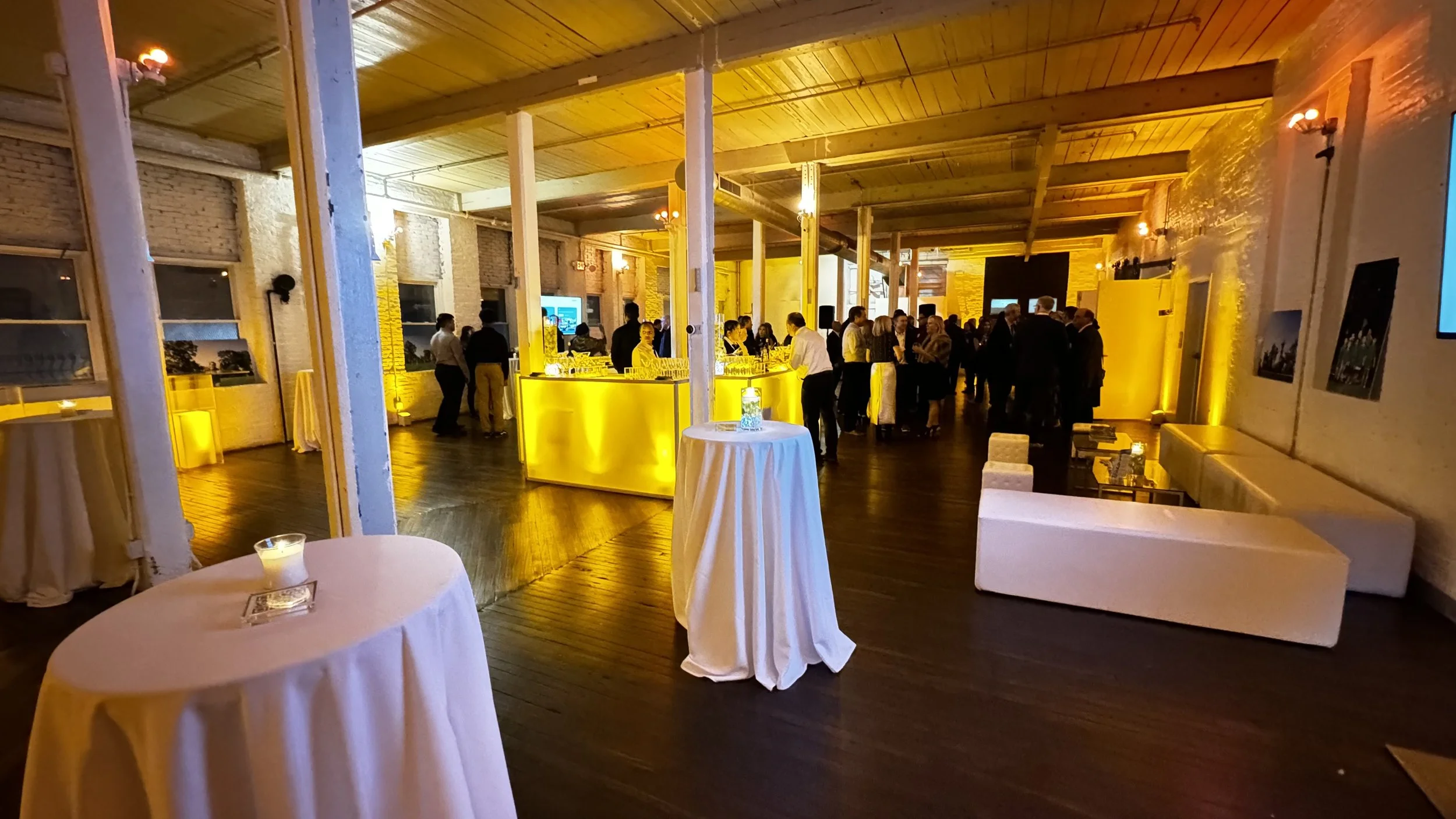 Elegant cocktail event in the Wilder Gallery at The Knowlton, featuring a modern bar setup, ambient lighting, and a sophisticated atmosphere ideal for corporate gatherings and networking events.