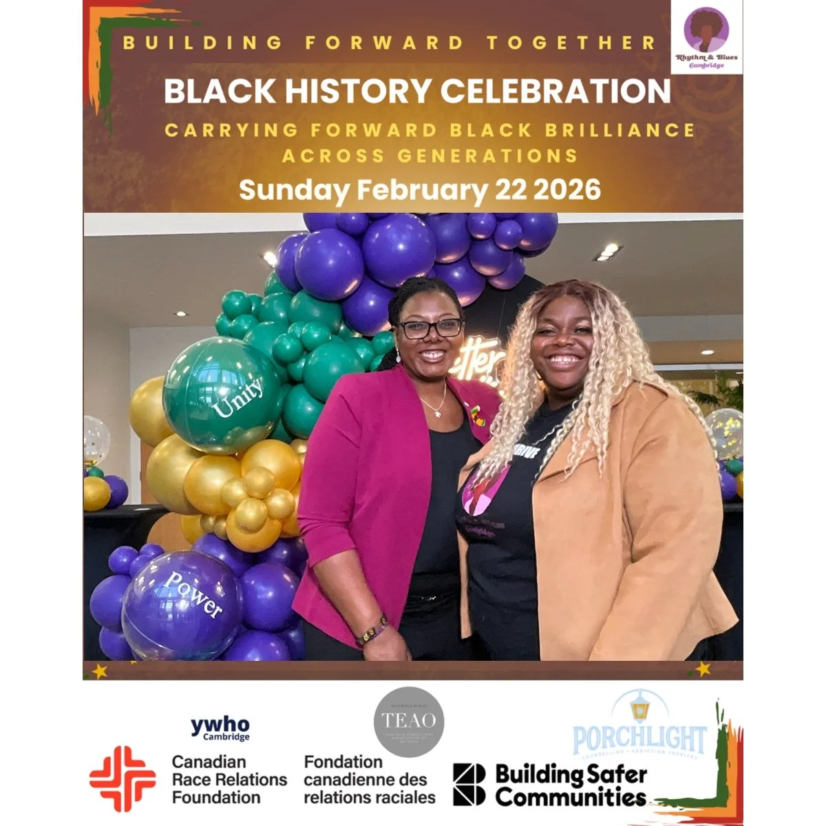 Two women standing together at a Black history celebration event, smiling, with colorful balloon decorations in the background. The event banner above them reads "Building Forward Together Black History Celebration, Carrying Forward Black Brilliance 