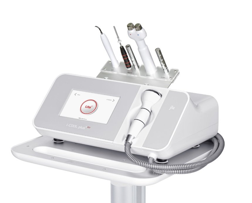 Medical device with a touchscreen display, multiple handheld instruments, and a flexible hose, used for skin or facial treatments.