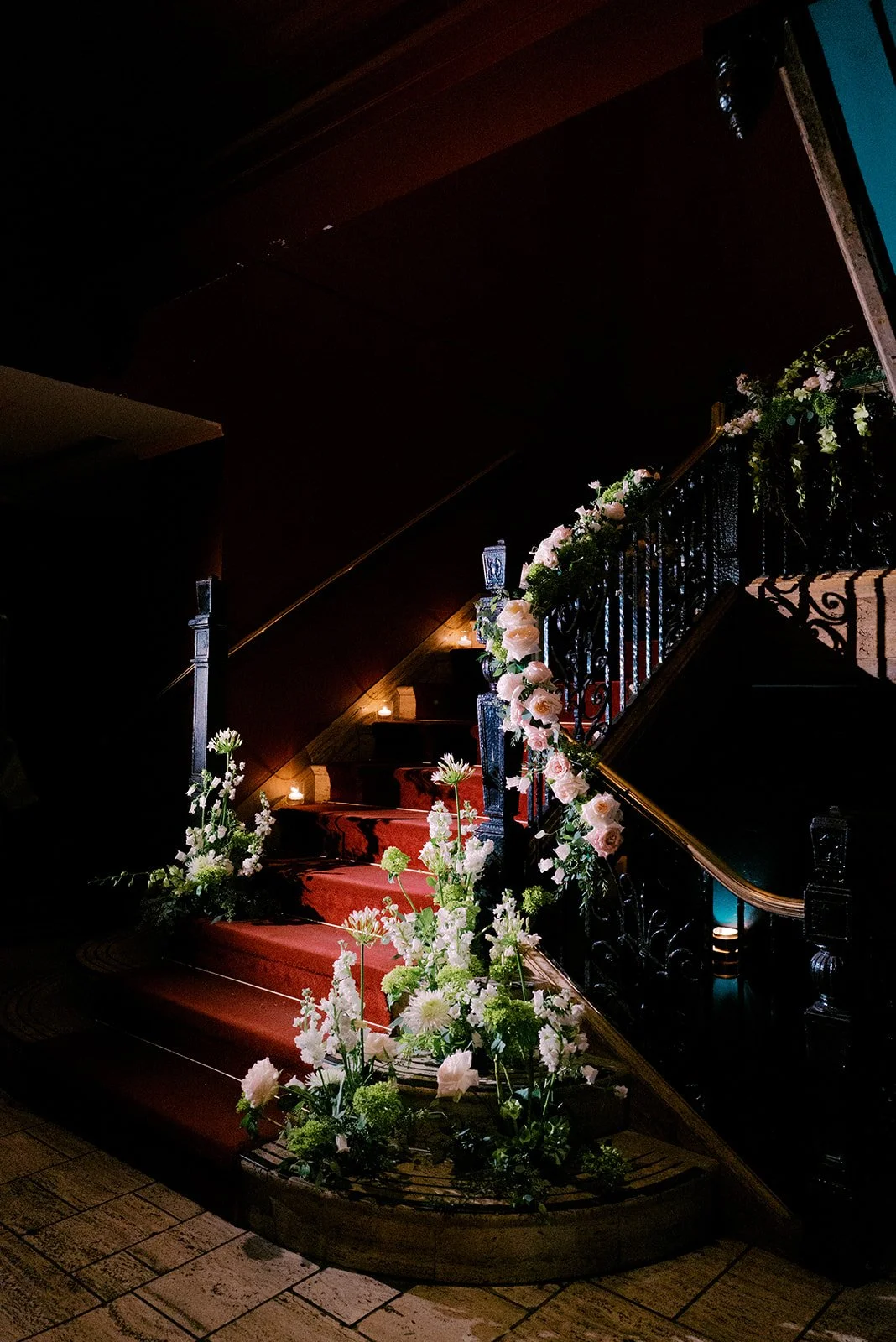 The staircase to the Georgia Room venue decorated with florals for a Wedding 