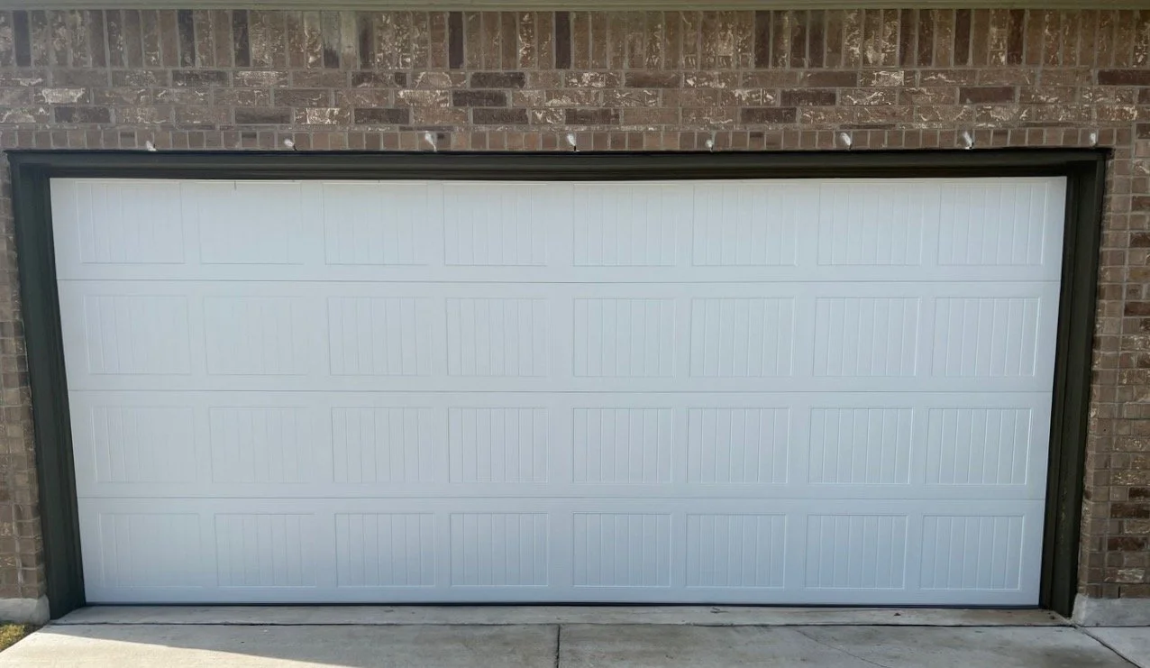 C.H.I. model 5250 short stamped carriage garage door in white with arched windows
