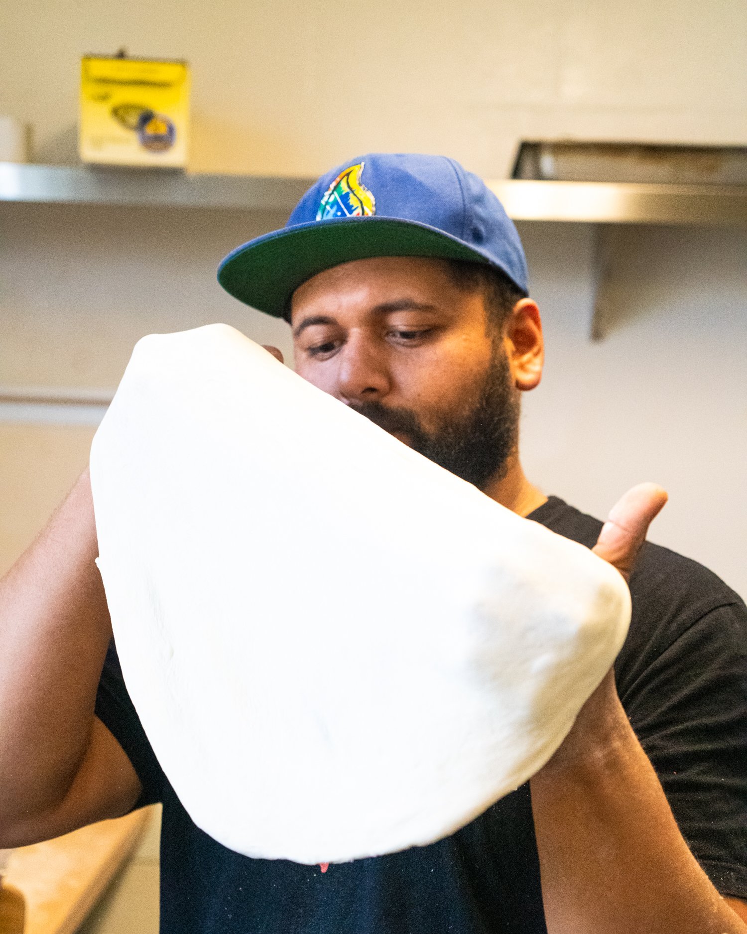  Head Chef Angel stretches dough.  