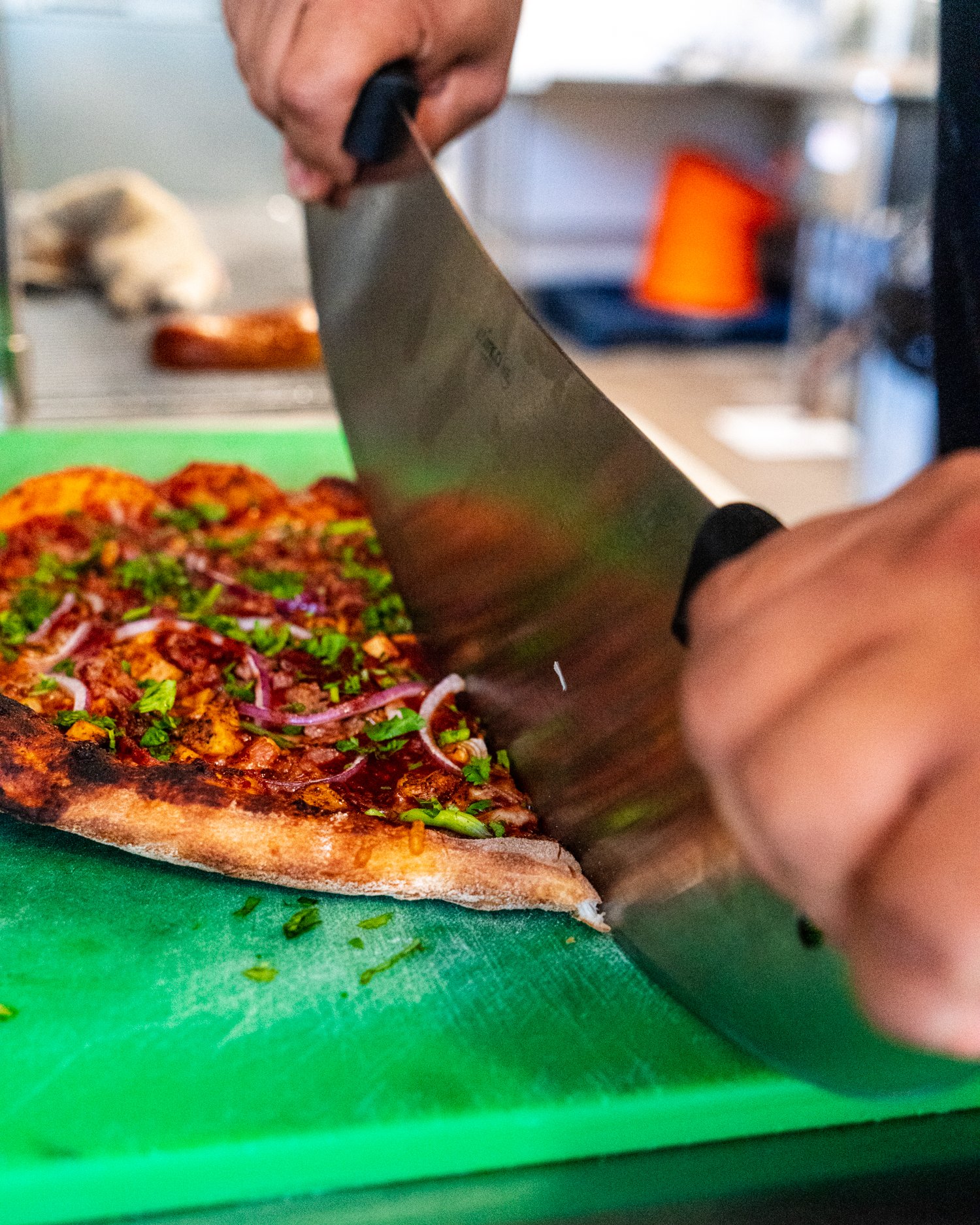  Our Buffalo Chicken pizza is one of our most popular, and for good reason! Blackened chicken breast is layered with red onion, mozzarella and provolone cheeses, a tangy blue cheese ricotta spread, Frank’s Red Hot, and green onions.  