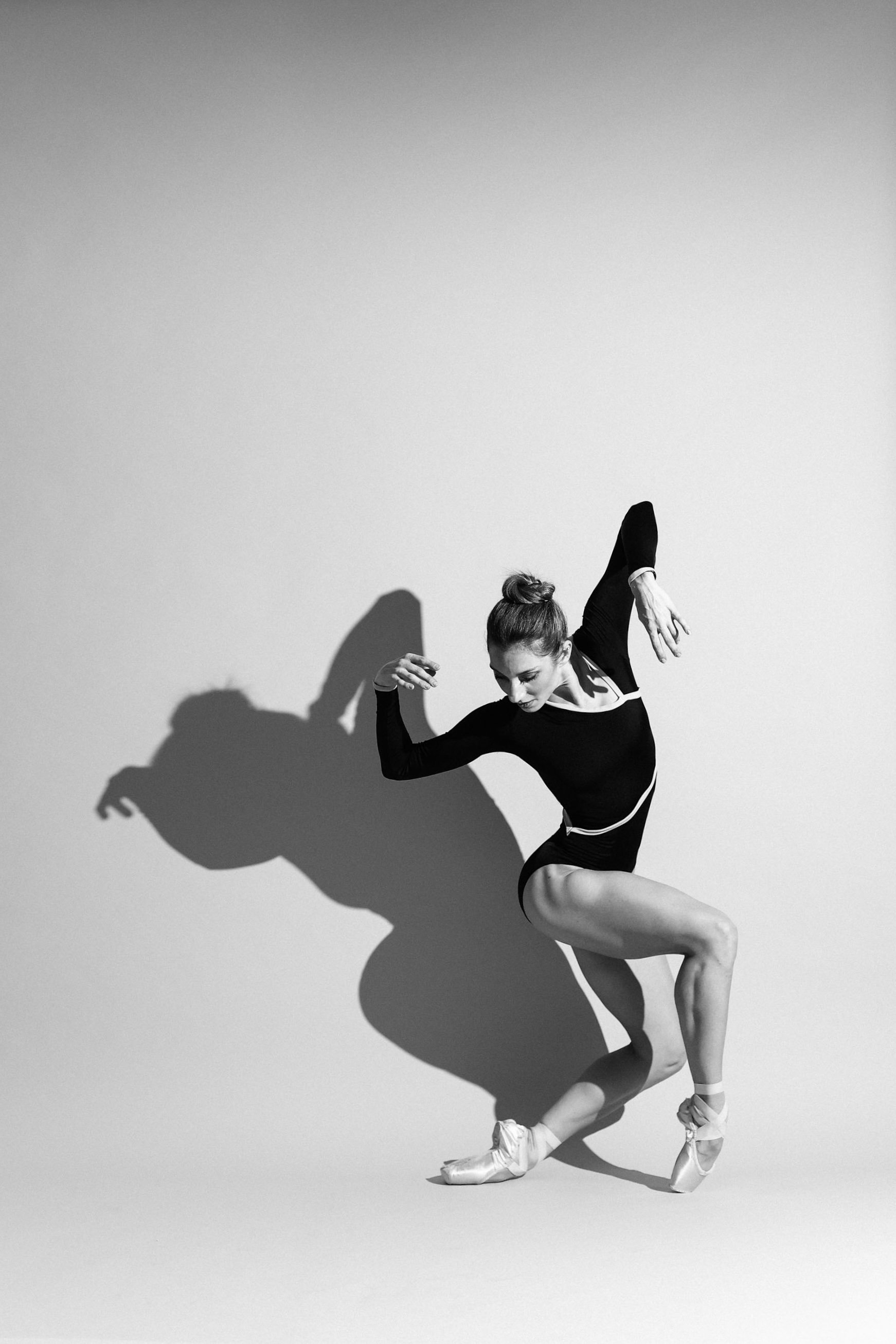 Caught in an impressive dip over her pointe shoes, a dancer performs a free fall.