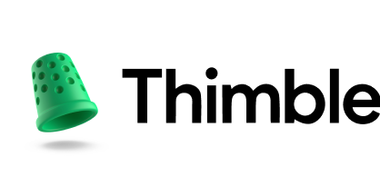 Green rubber thimble with black dots on a pink and white sewing needle and thread background.