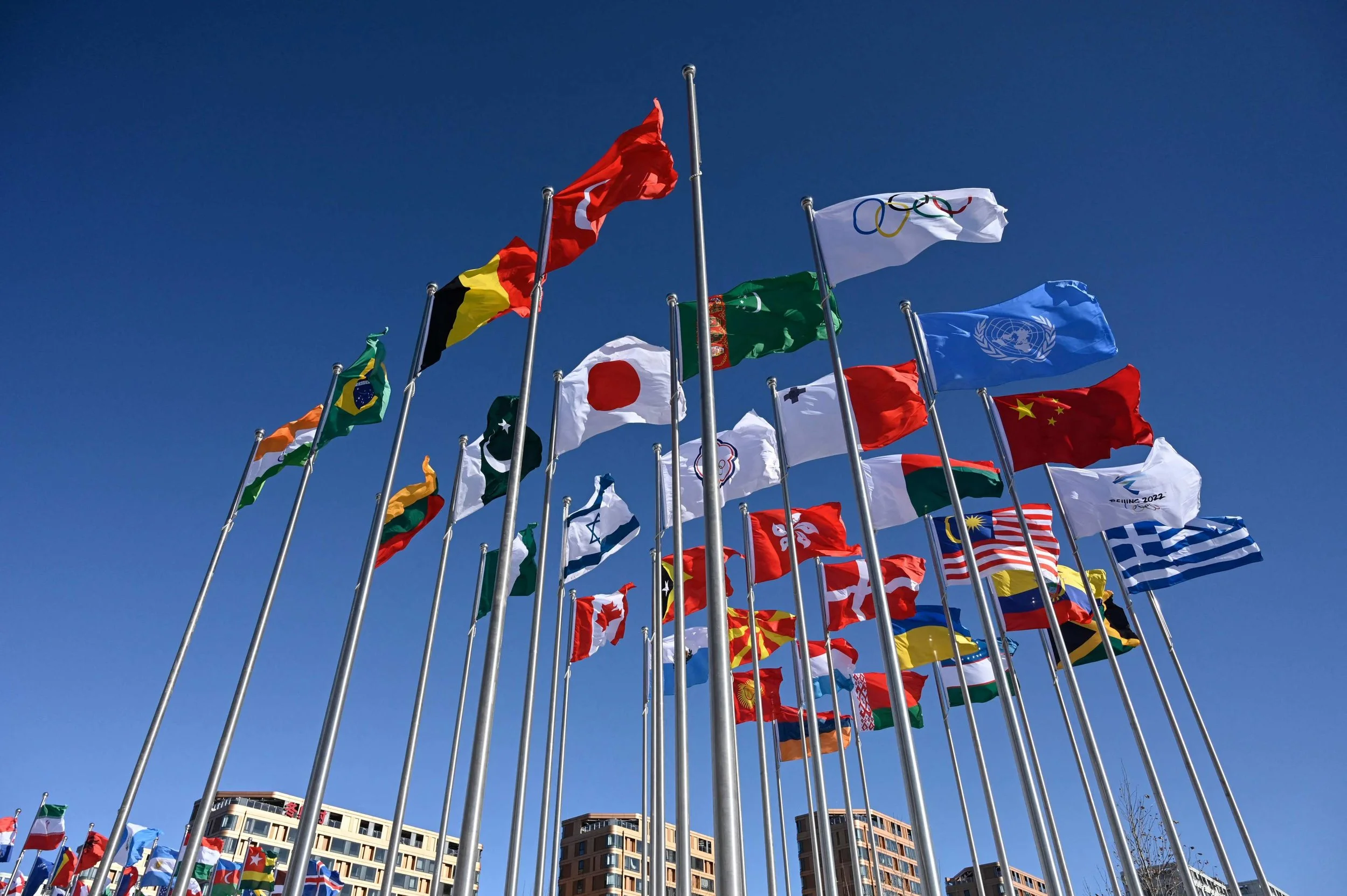 An image of different countries' flags flying