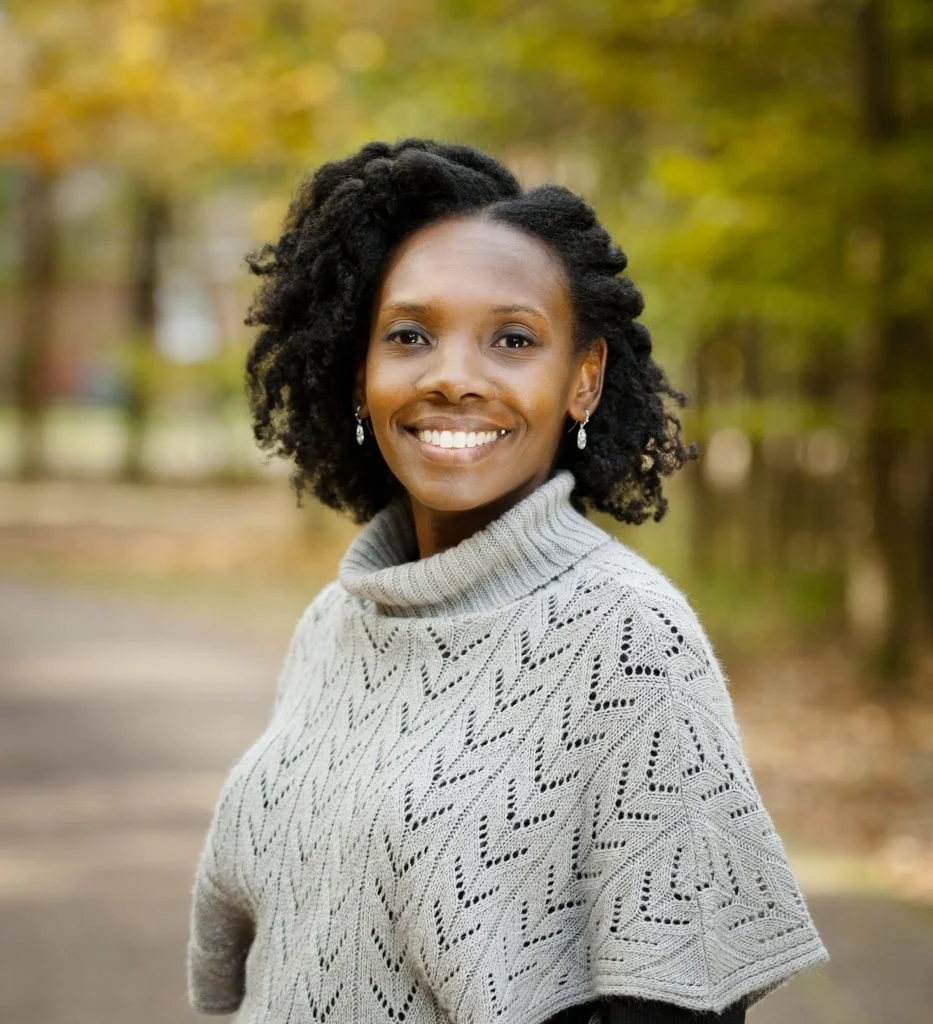Portrait of Dr. Pierce with a blurred landscape background.
