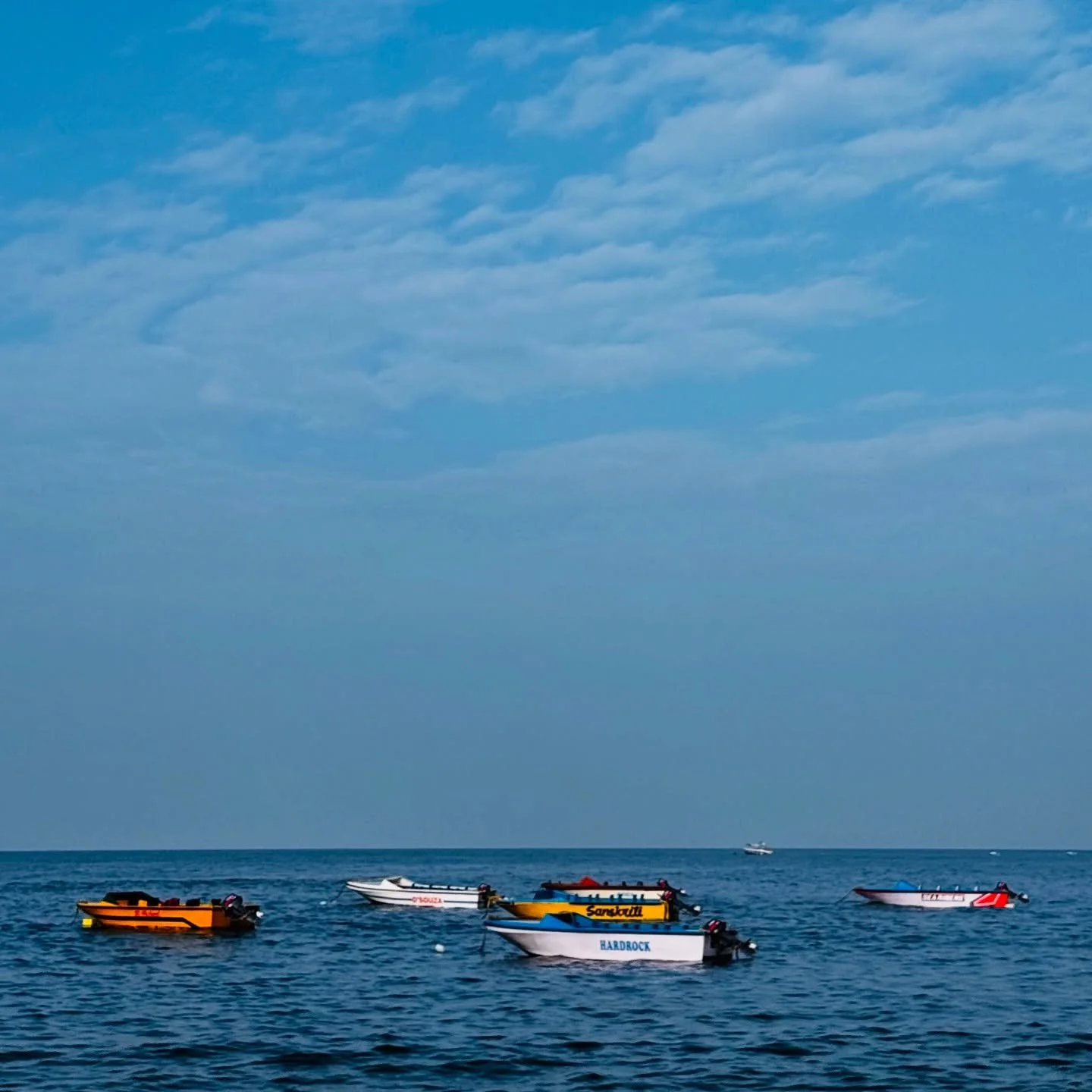 ..::W A I T I N G::..
.
.
Floating Dreams

On quiet waves, the boats repose,
Beneath a sky where soft clouds flow.
Each hull a story, still and bright,
Drifting gently in morning&rsquo;s light.

The sea, a mirror vast and wide,
Holds their journey, y