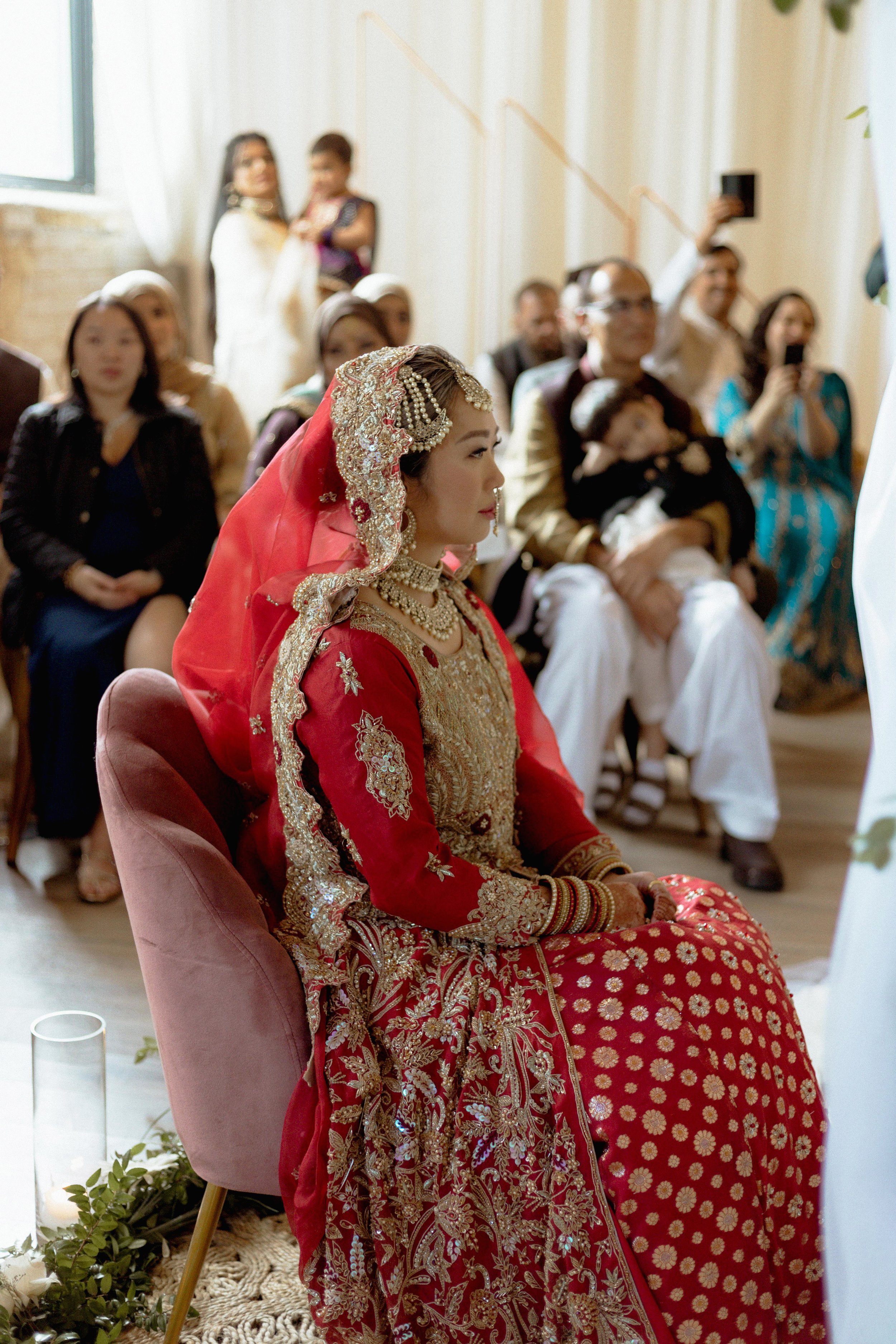 bride sitting in chair during wedding ceremony