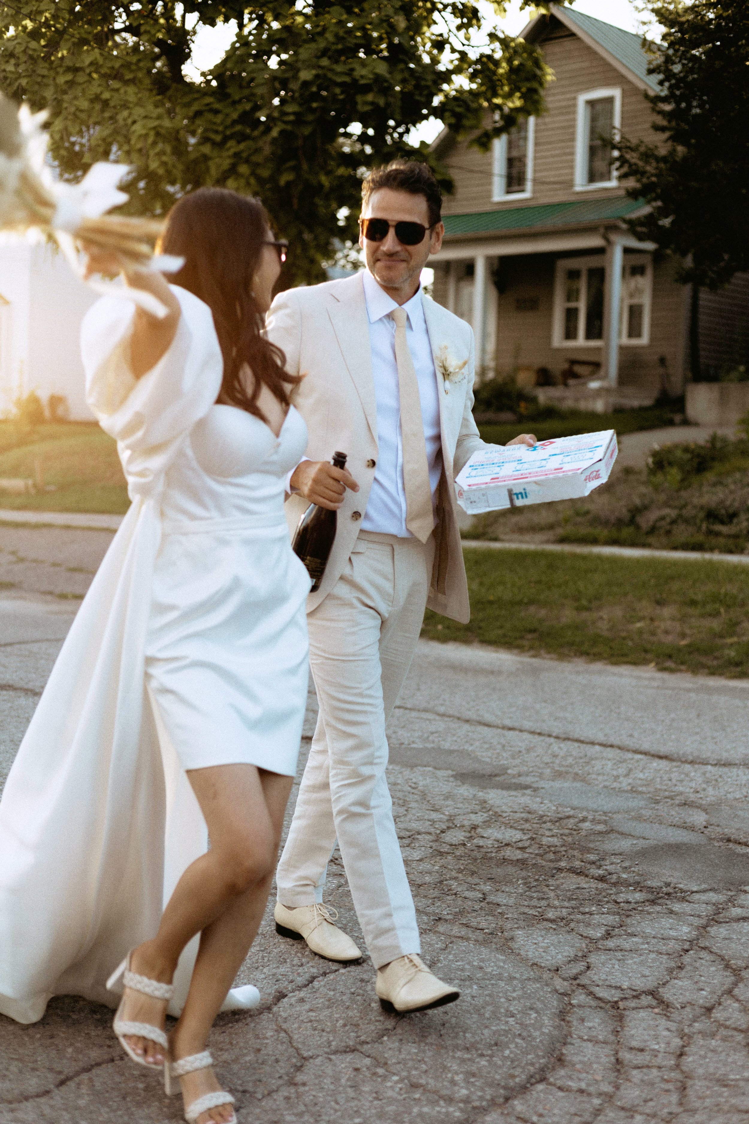 bride and groom walking down the road to continue celebrating their elopement in toronto