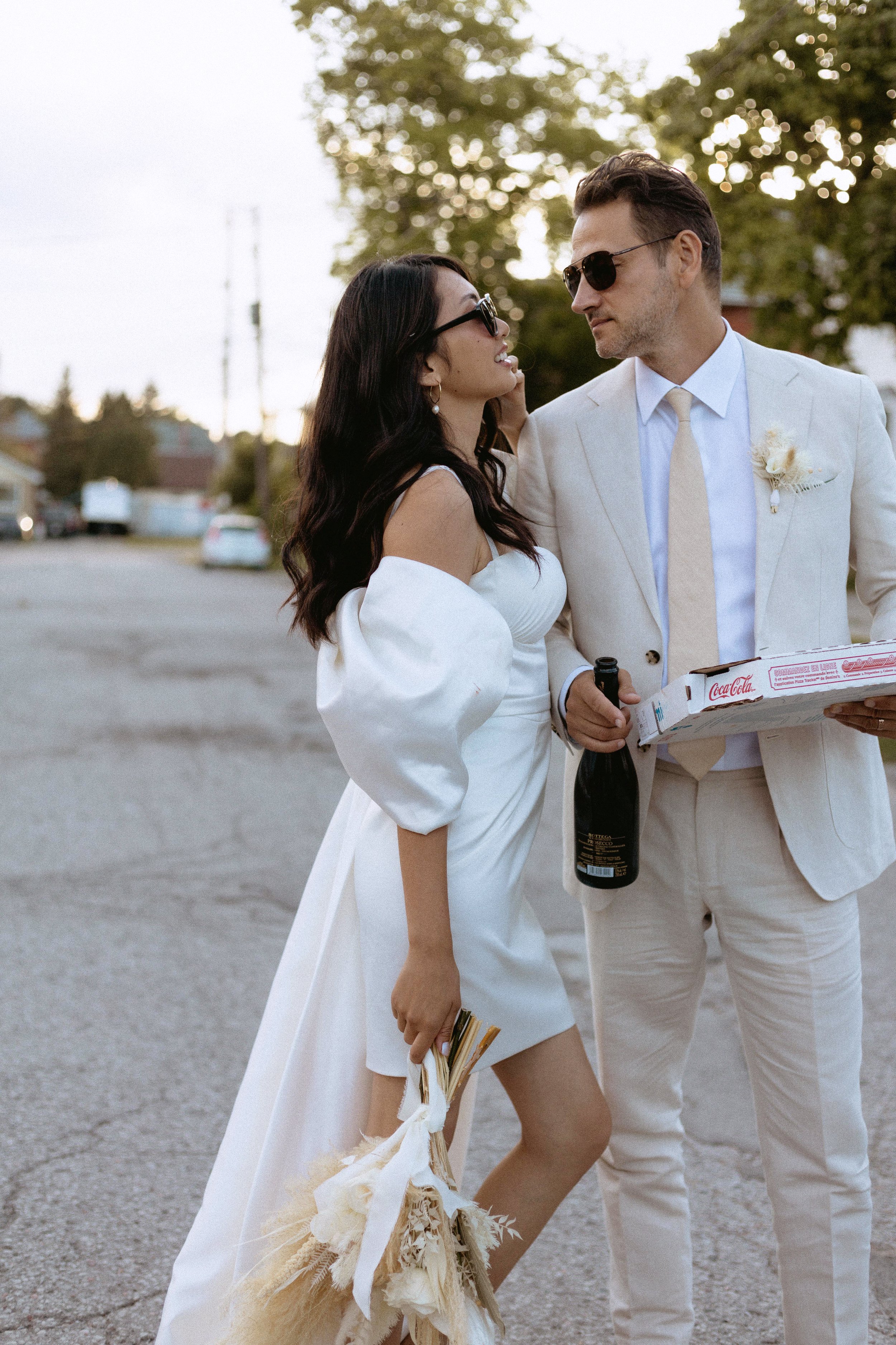 bride and groom walking down the road to continue celebrating their elopement in toronto