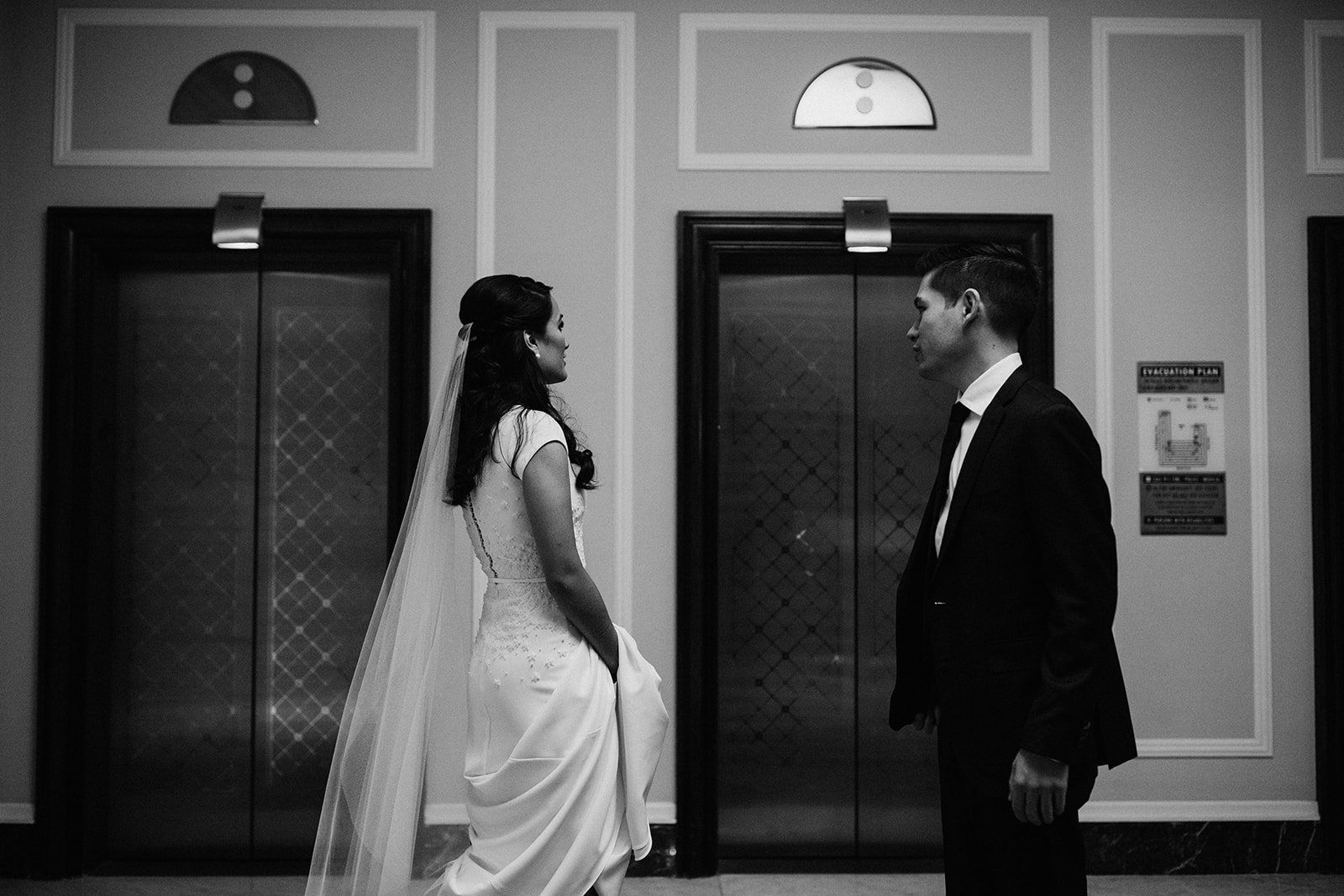  bride and groom waiting for an elevator  