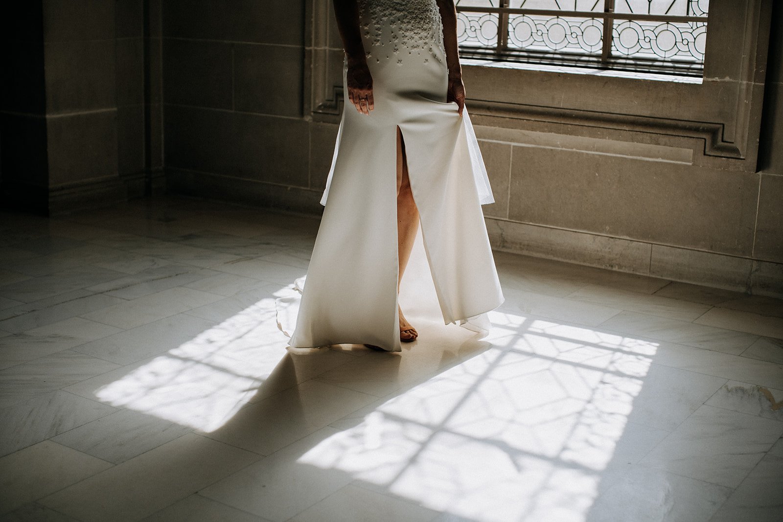  brides lower body holding her dress  