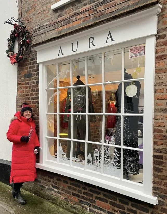 Pipse artist Philippa Edwardson poses next to her winter window design