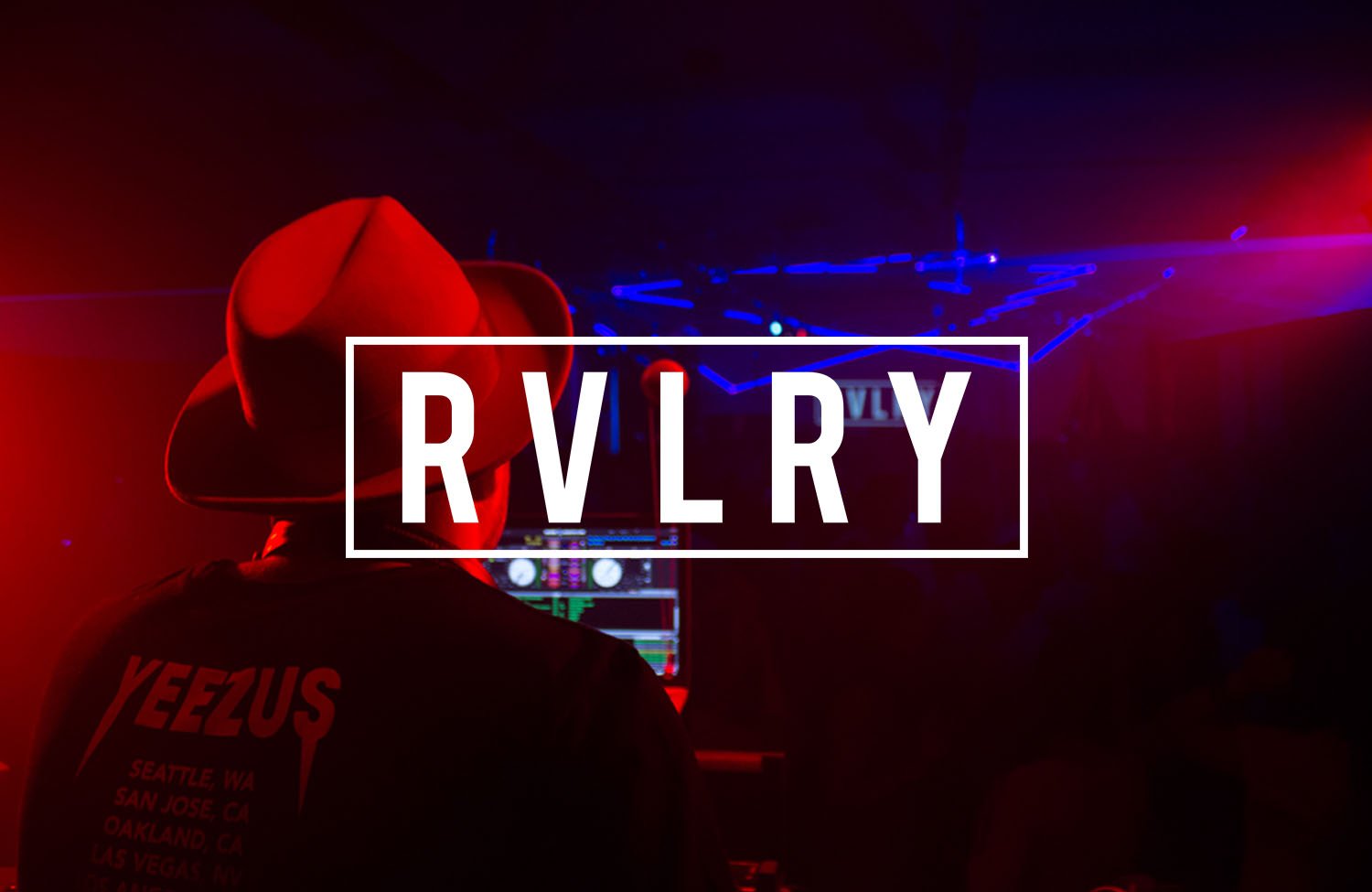 DJ performing in a dark, neon-lit club with 'RVLRY' text overlay.