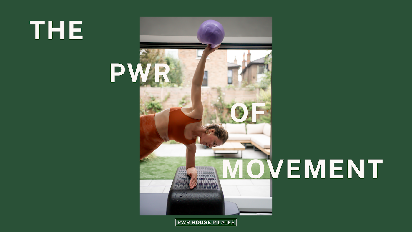 A woman performing a plank exercise with one arm holding a purple kettlebell, on a black exercise step in a gym or studio with an outdoor patio and garden view in the background. The text overlay says "The Power of Movement" and "PWR House Pilates."