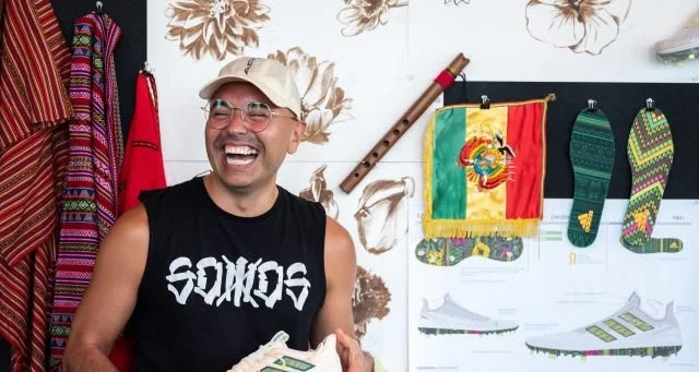 Designer Julio Aleman shows off the hand painted flowers used in the design.