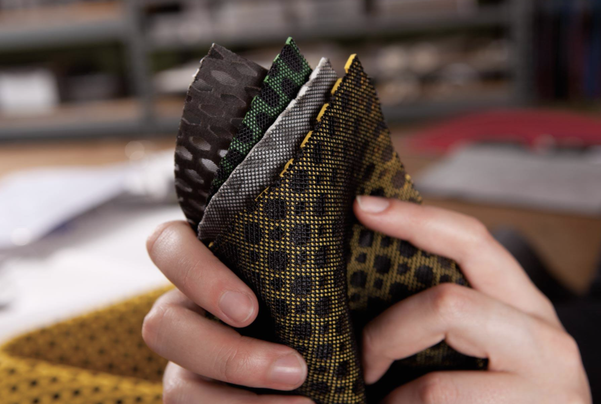 Ariaprene
Ecological: degradable, non-toxic, cleaner manufacturing process. 
Design: Fully customizable, a wide variety of colors available, compound material, moldable. 
Performance: flexible, lightweight, insulting, shock absorbing, breathable, sup