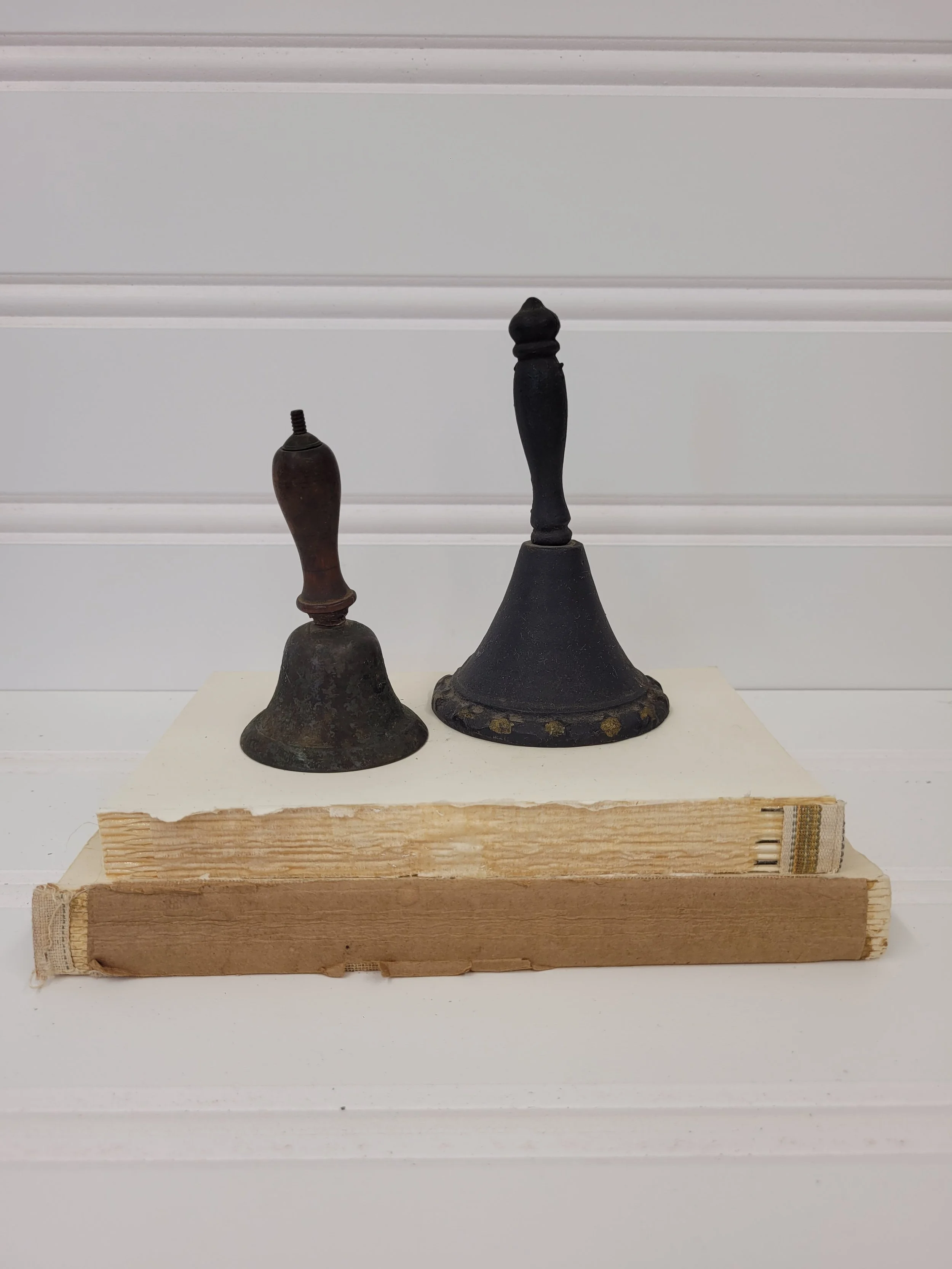 set of 2 old bells - metal and cast iron with wooden handle