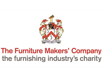 Logo of The Furniture Makers' Company featuring a crest with two lions, a shield, and a knight's helmet, with text below reading 'The Furniture Makers' Company' and tagline 'the furnishing industry's charity'.