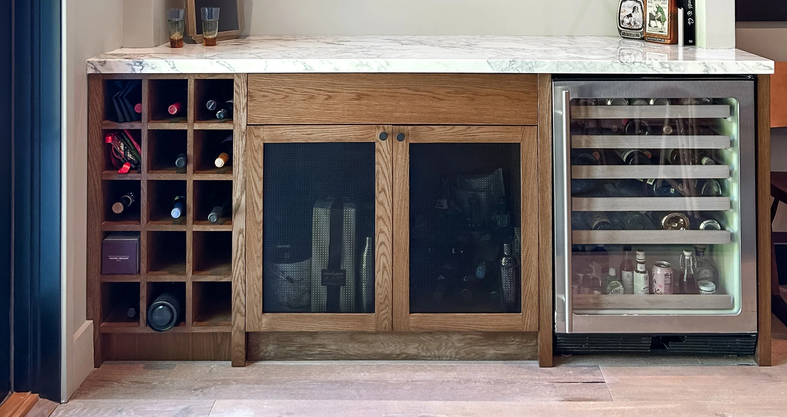 Wine storage and bar setup with a wine rack, cabinet, and beverage cooler on a wooden floor.
