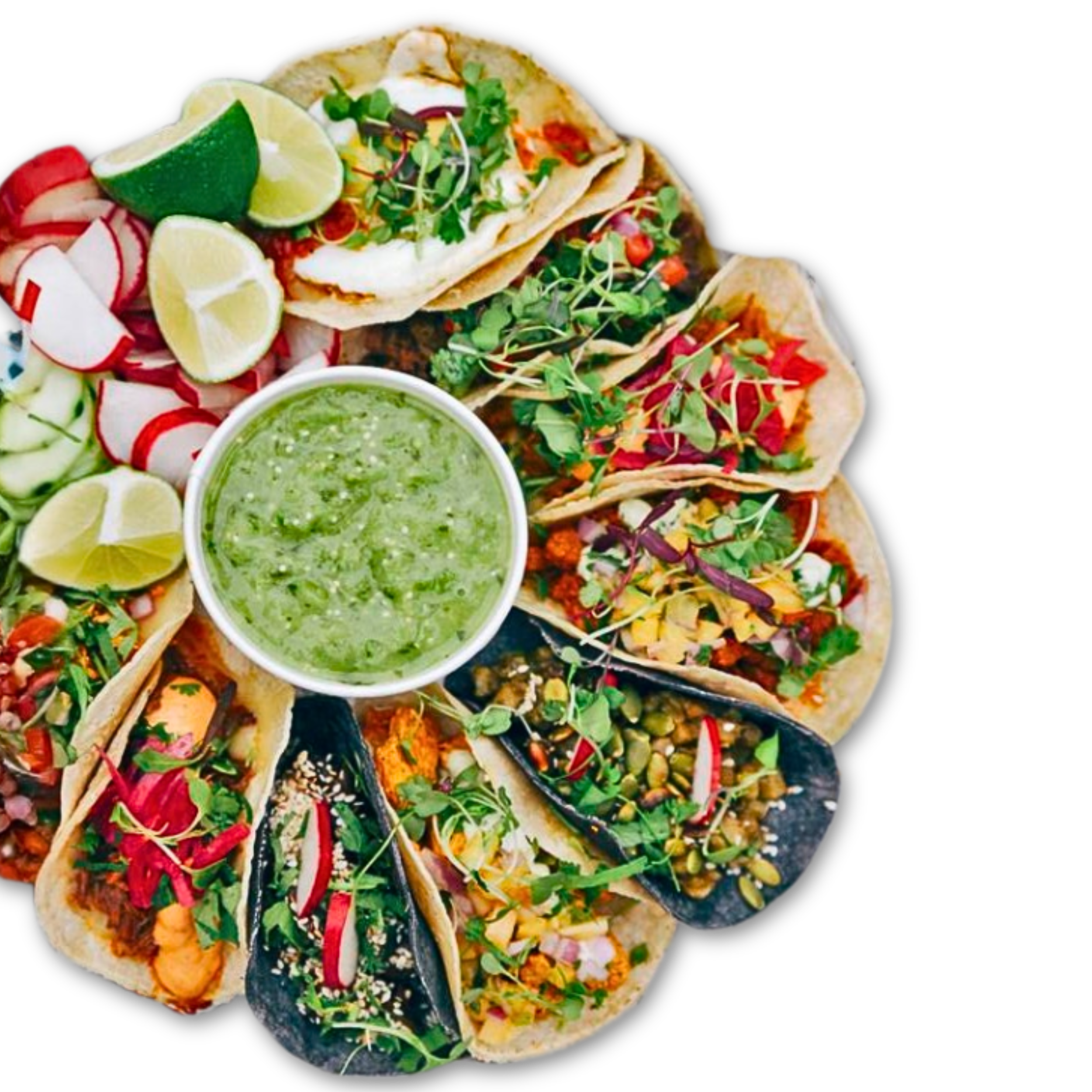 Assorted tacos with fresh cilantro, radishes, lime wedges, and a container of green sauce on a black background.