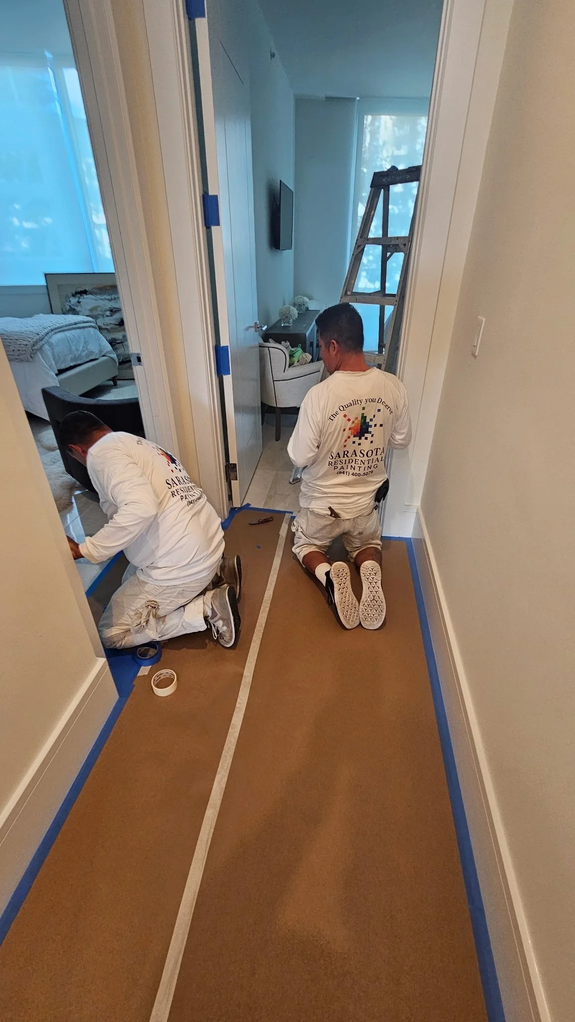 Sarasota Residential Painting team painting interior doors and trim at a Ritz-Carlton Residences condo in Sarasota