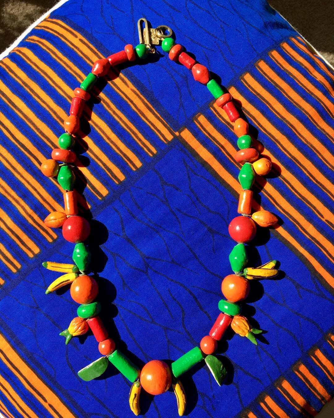 Carman Miranda inspired, handmade clay beads from Brazil, highlighting African wax print! 
#frutta#tropical#oohlala#waxprint#OOAK#Brazil#beachjewelry#beachparty#stonesglassbones#vintagebeads#ethnicjewelry#