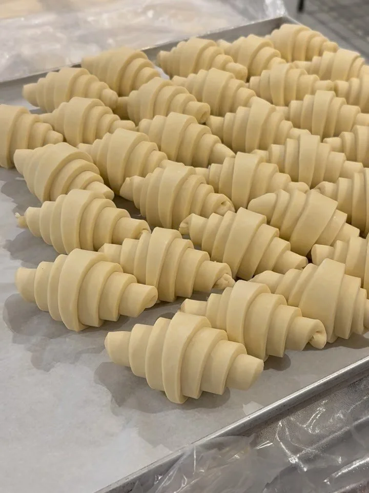 Early mornings in the bakery!🧡✨

Swipe to take a closer look at the making of our Plain Croissants. Shaped and baked with lots of love, it&rsquo;s perfect on its own, and even better as the base for our Brunch menu options.

#pastries #croissant #ba