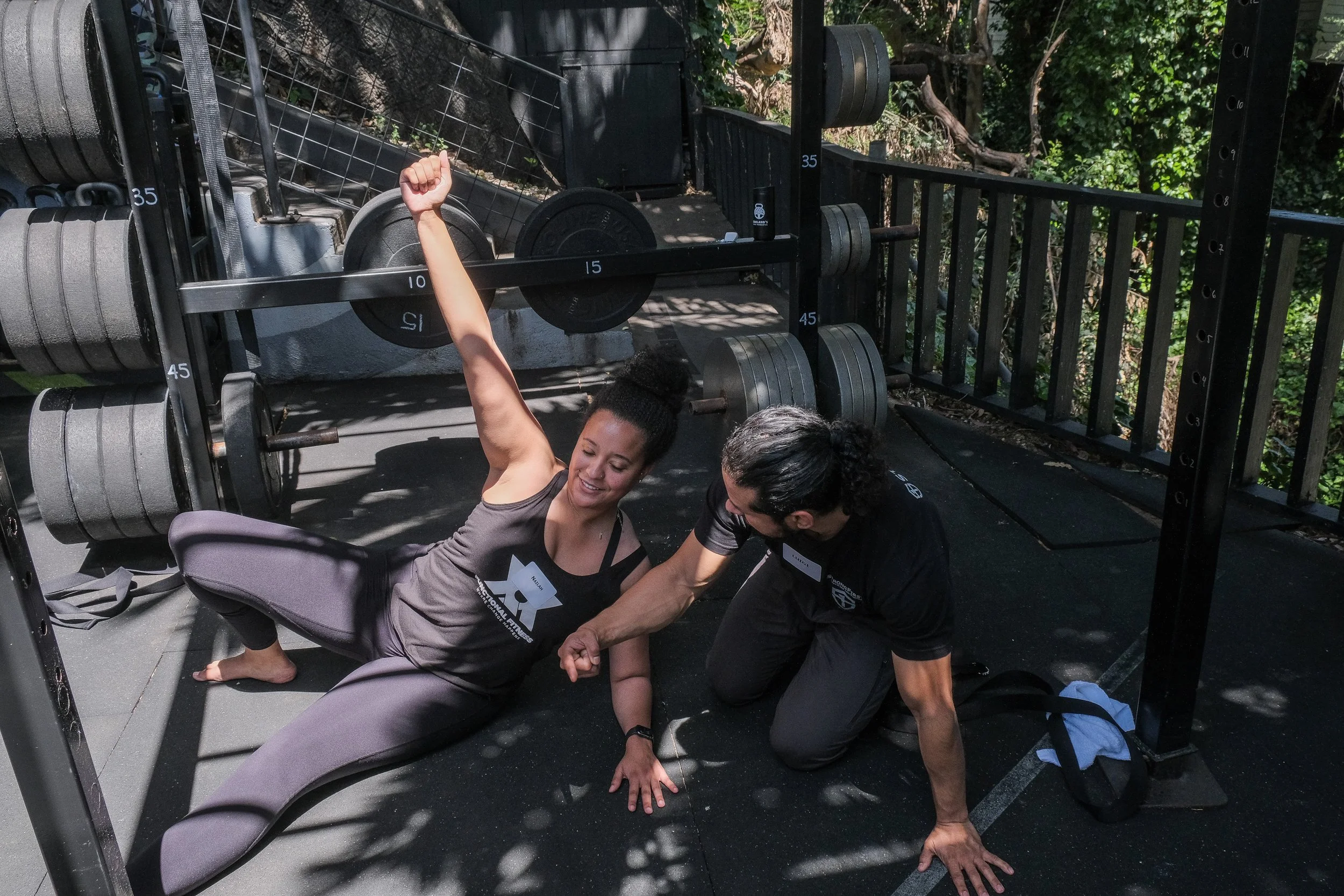 Coach Luis guides a student through the Turkish Get-Up during a kettlebell training session at Oakland’s Most Powerful, focusing on technique, positioning, and core stability.