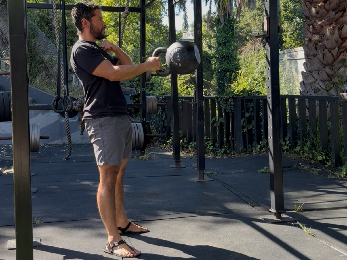 Luis Del Toro of Oakland's Most Powerful at the top of a one-arm kettlebell swing with a 48kg bell