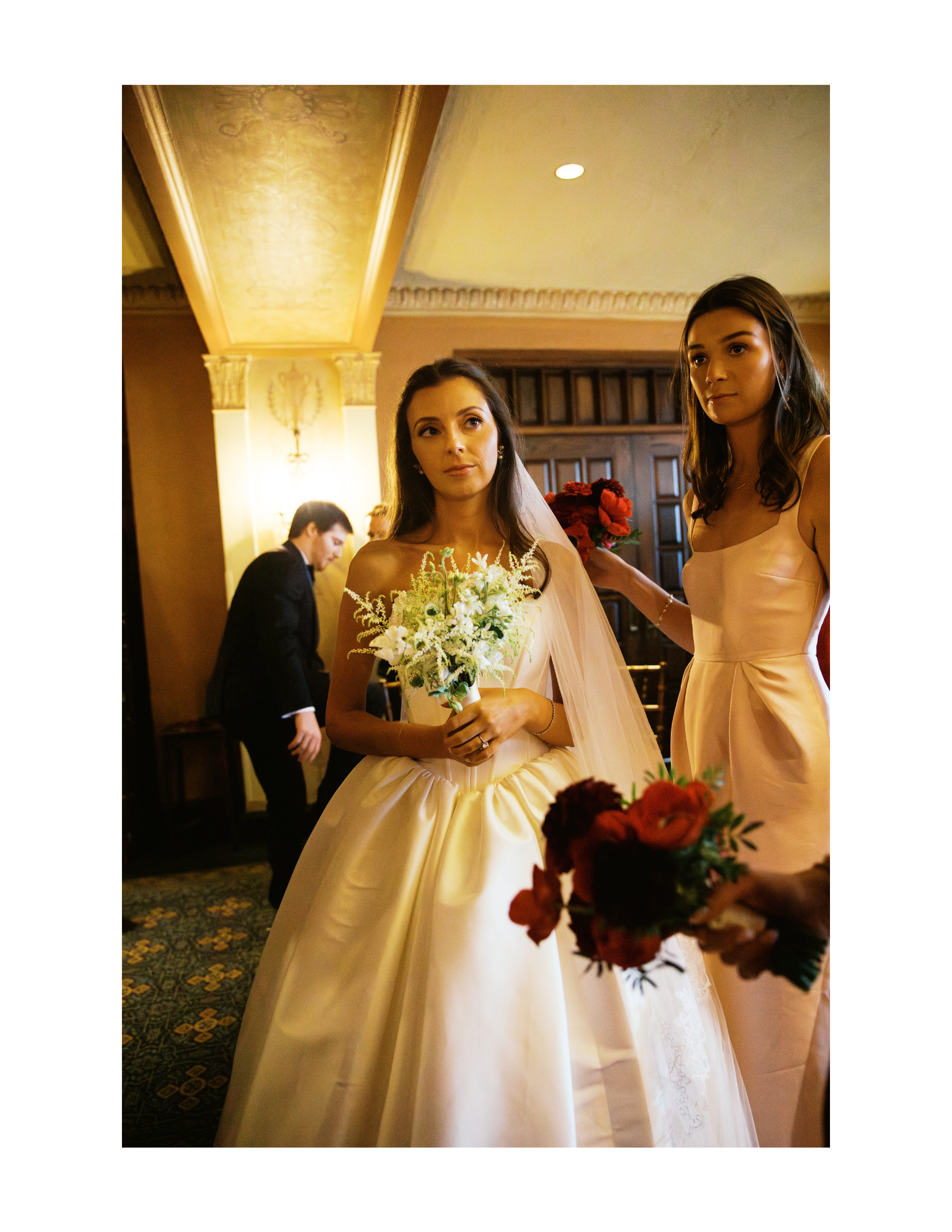 The bride stands with a bridesmaid before the ceremony. Photograph taken by wedding photographer Sheridan Mangold at Congressional Country Club in Bethesda, MD.