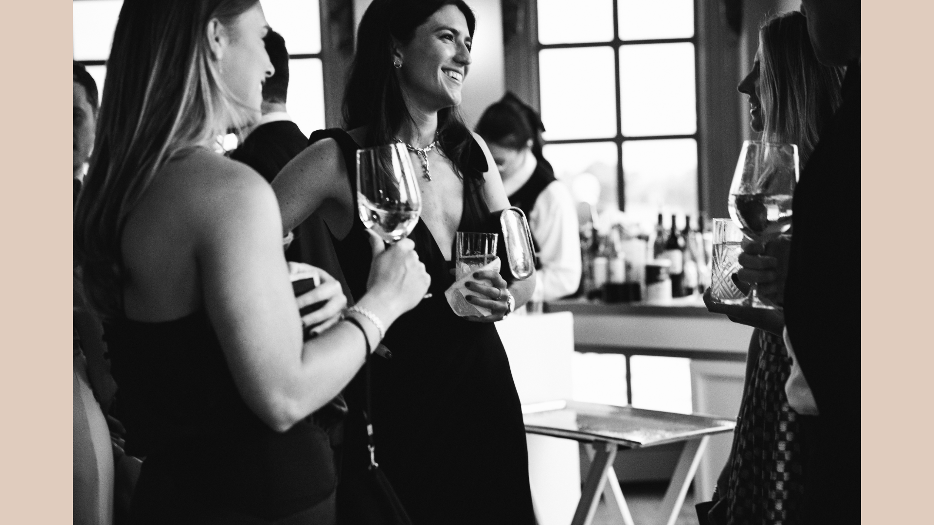 Guests enjoy cocktail hour together. Photograph taken by wedding photographer Sheridan Mangold at Congressional Country Club in Bethesda, MD.
