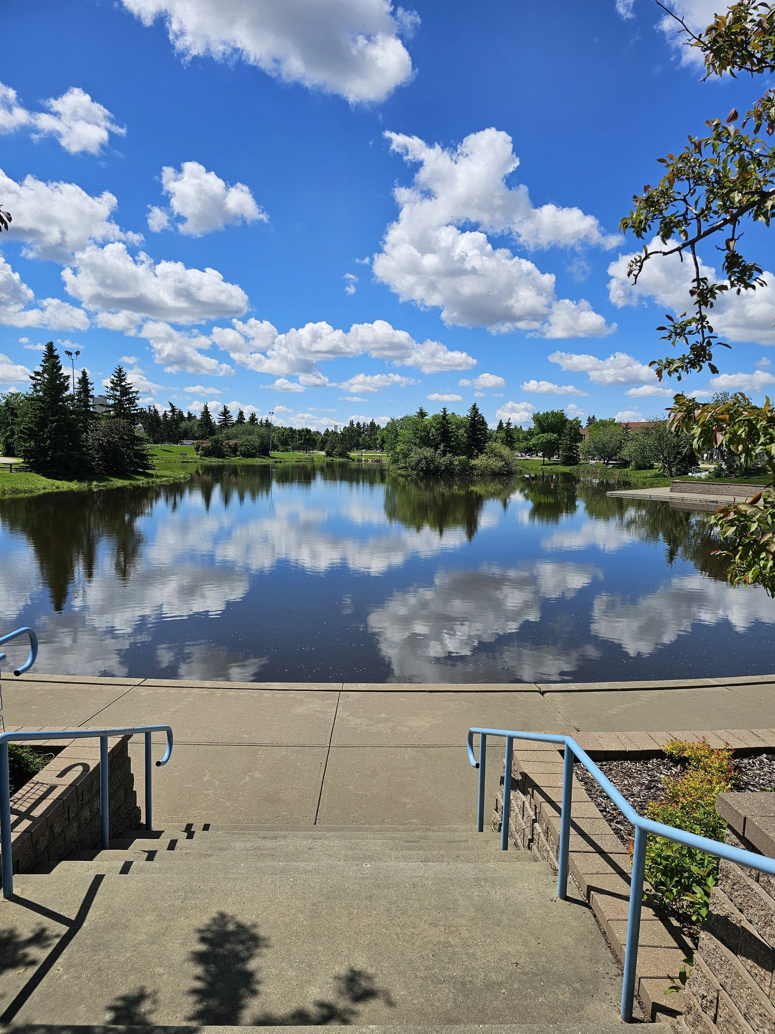 Sunny walking path along the lake area in Sherwood Park Alberta on a beautiful summer day