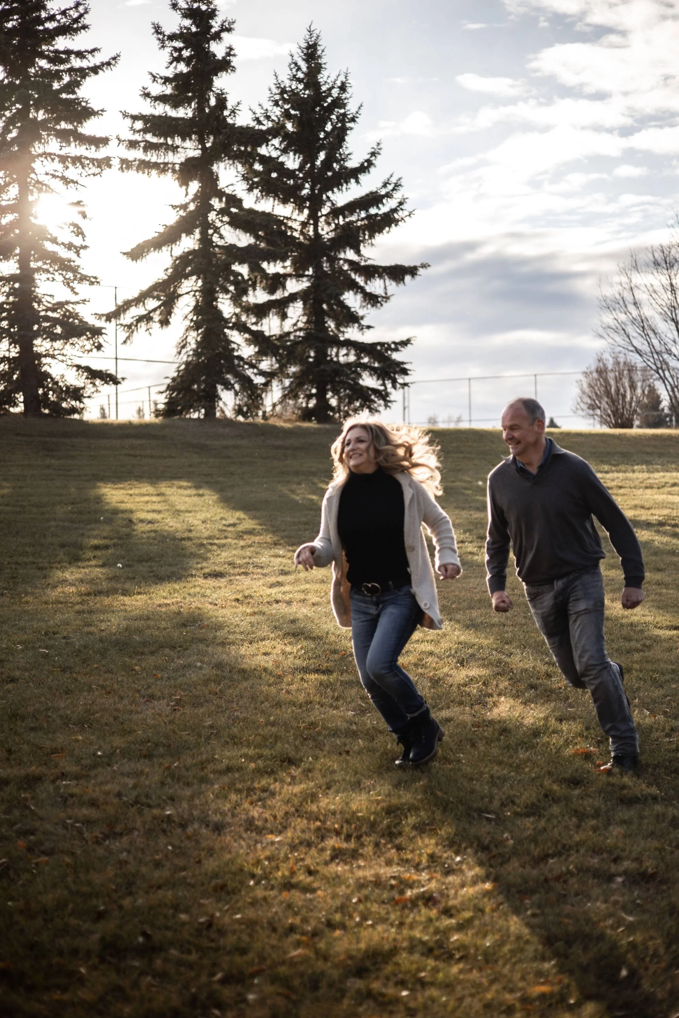 happy midlife couple running and laughing