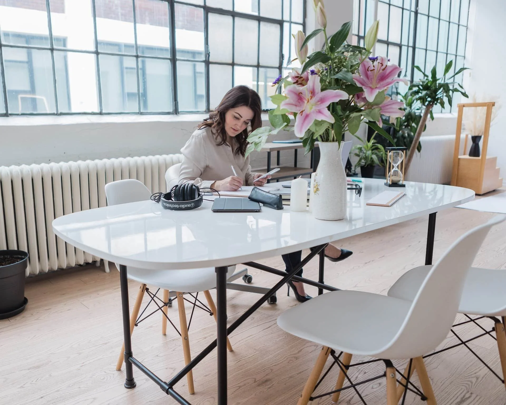 Woman sitting at a desk planning a web design project