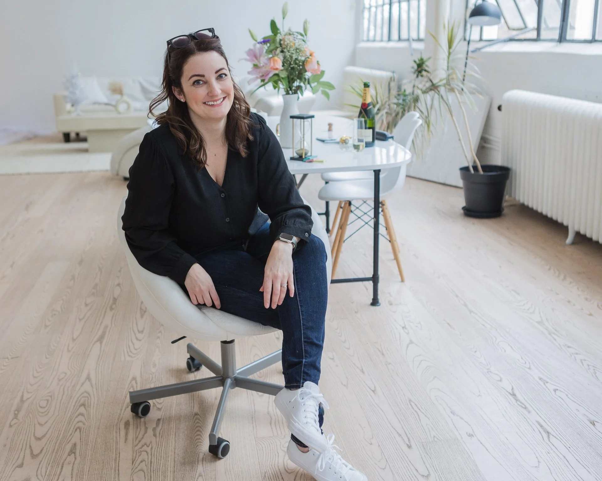 Woman sitting on a chair in a modern white loft studio