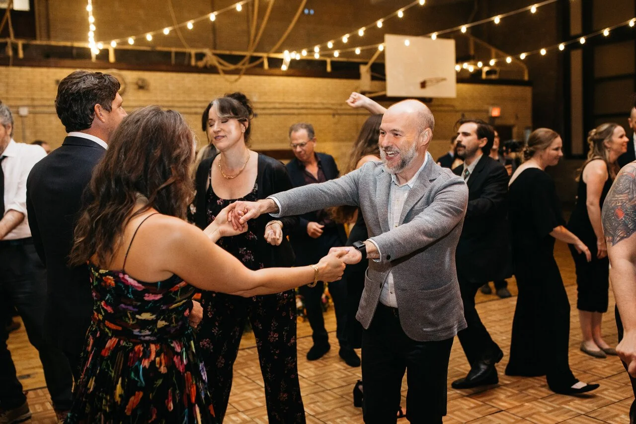 105-guests-dancing-warm-light-reception-bok-gymnasium-philadelphia.jpg