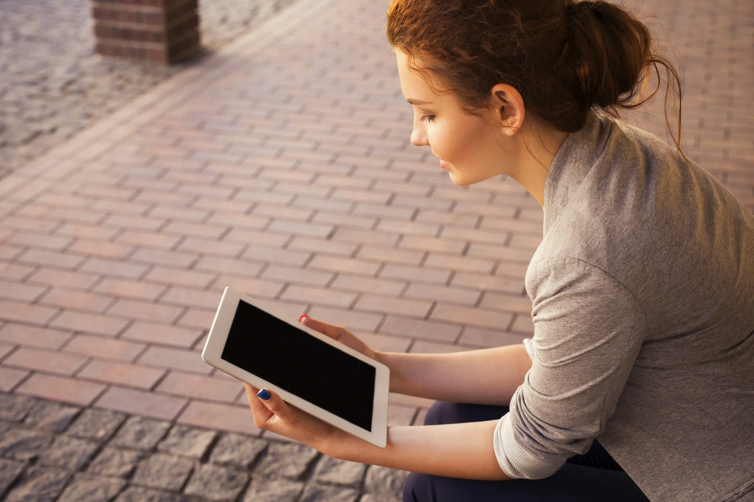 woman reading a tablet