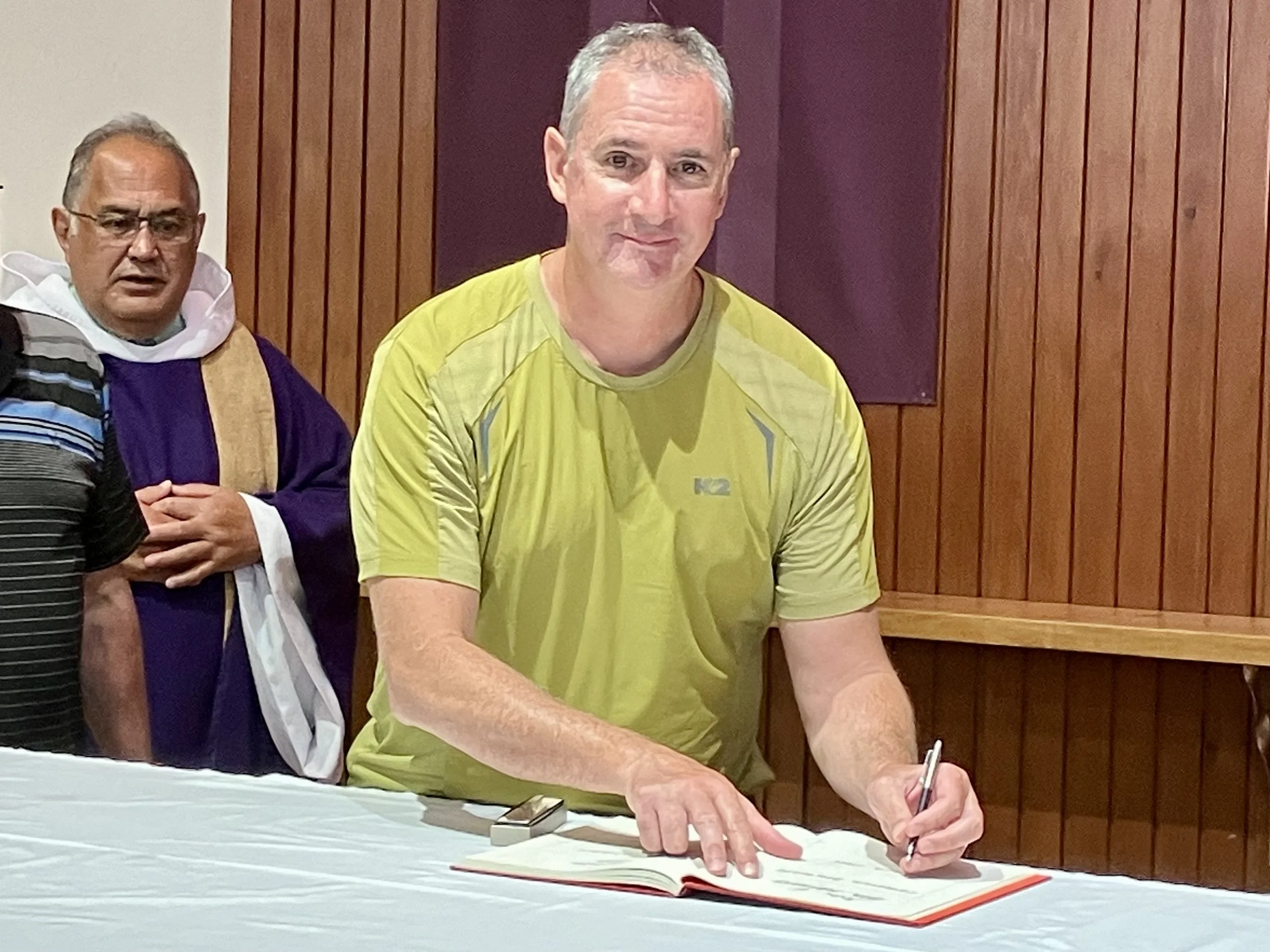 Cameron signing the Book of the Elect