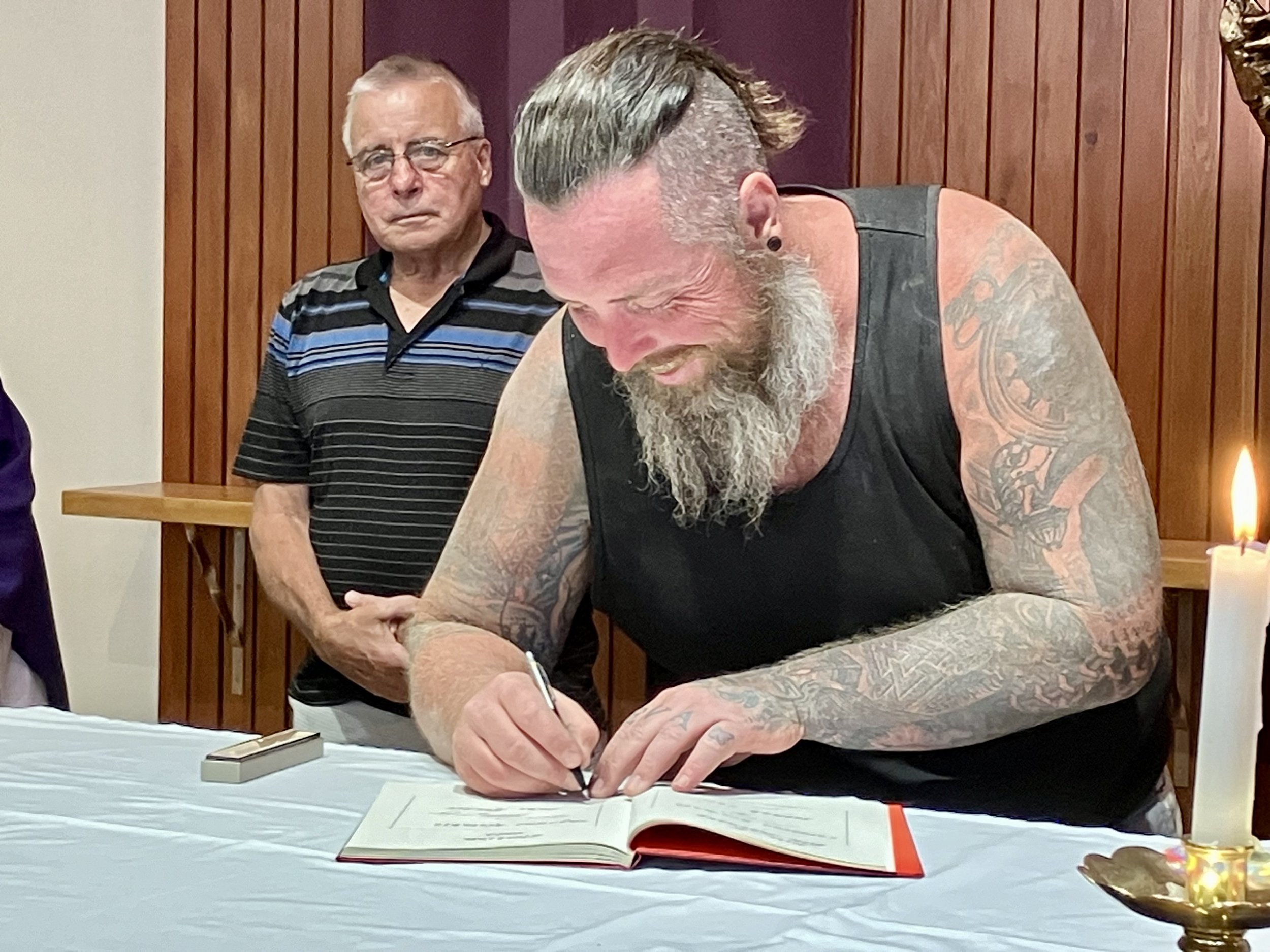 Luke signing the Book of the Elect