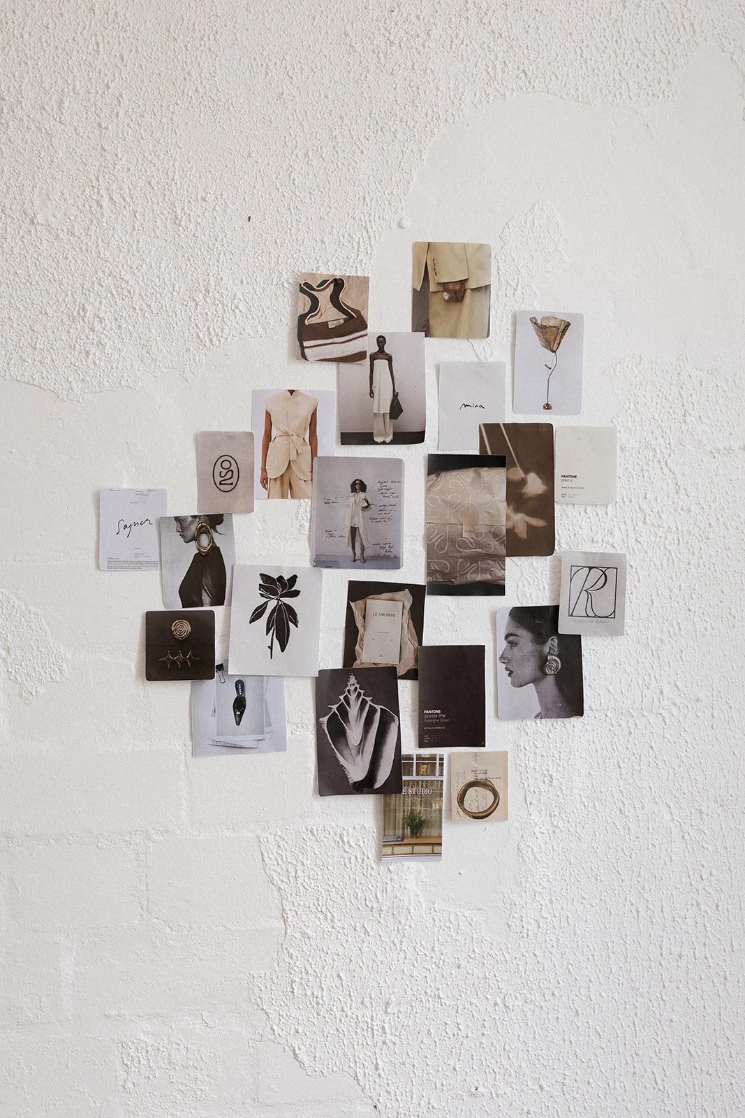 A collection of fashion and art-inspired photographs, sketches, and printed images arranged in a collage on a white textured wall.