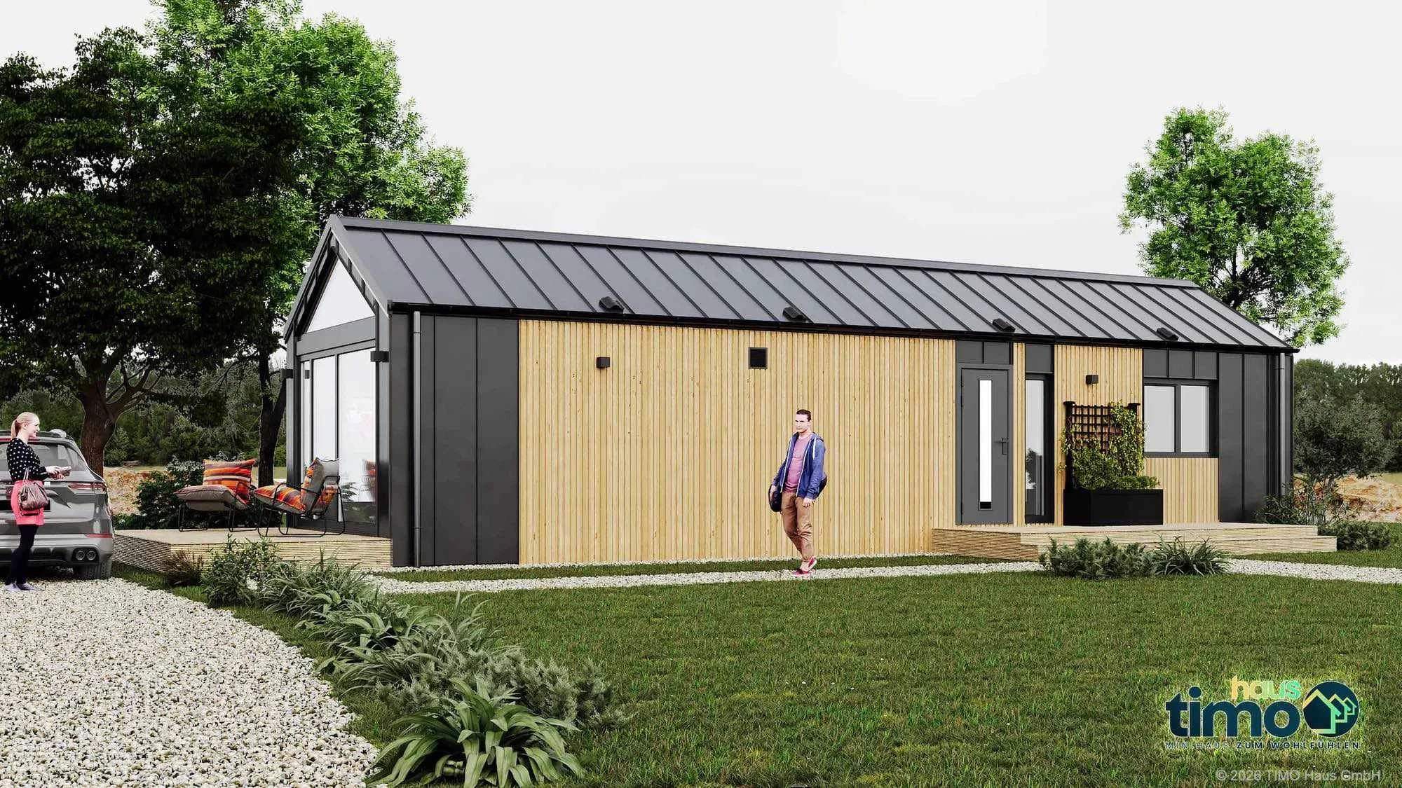 Haus MW52-2 — Tiny House Außenansicht mit Holzfassade, Anthrazit-Stahlrahmen und Satteldach im Garten (Foto: TIMO Haus Münster)
