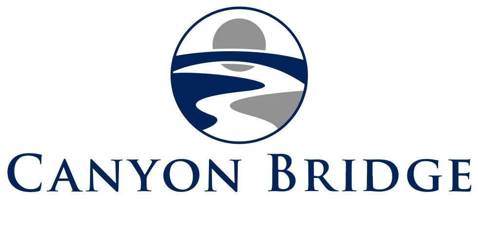 Canyon Bridge logo featuring a stylized circular design with a path or river and sunset elements above the text "Canyon Bridge."