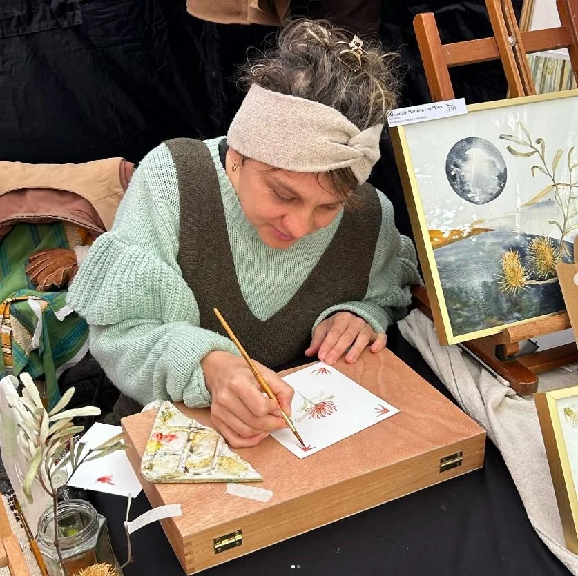 Jessika is doing life paining of a Tasmanian Waratah - native Tasmanian flora in watercolour medium at Salamanca Market in Hobart