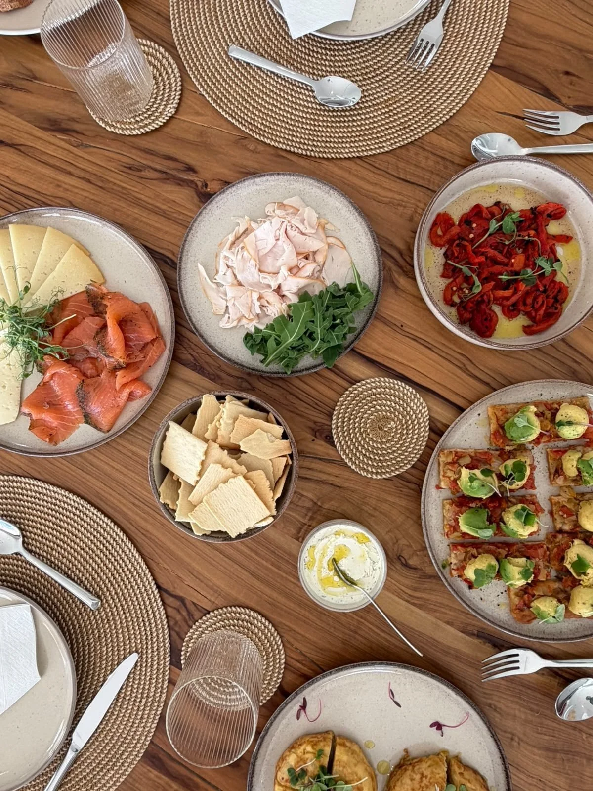 Lunch of salads, cheeses and sharing dishes on a wooden villa table in Mallorca